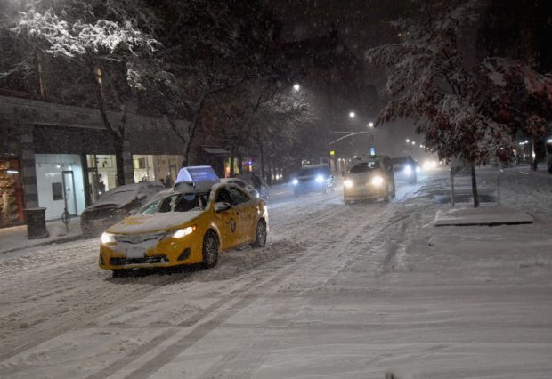 Cars are driving through snow and ice in Manhattan on November 15, 2018 in New York. - The National Weather Service is predicting snowfall totals of 2 to 4 inches in New York City. (Photo by Angela Weiss / AFP) (Photo credit should read ANGELA WEISS/AFP/Getty Images)