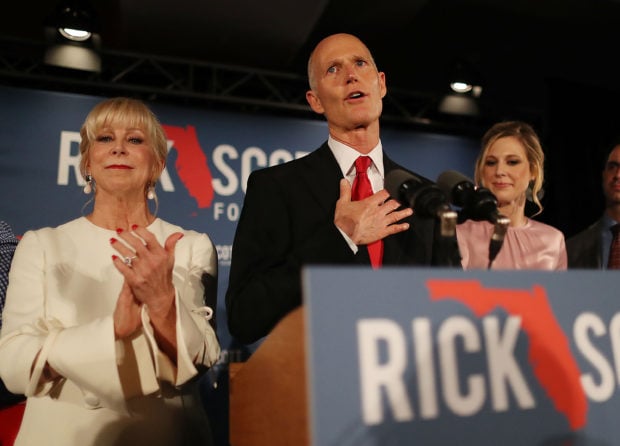 NAPLES, FLORIDA - NOVEMBER 06: Florida Governor Rick Scott speaks as he stands with his wife, Ann Scott, (L) and daughter Alison Guimard (R) during his election night party at the LaPlaya Beach & Golf Resort on November 06, 2018 in Naples, Florida. Governor Scott defeated Sen. Bill Nelson for the Florida Senate seat. (Photo by Joe Raedle/Getty Images)