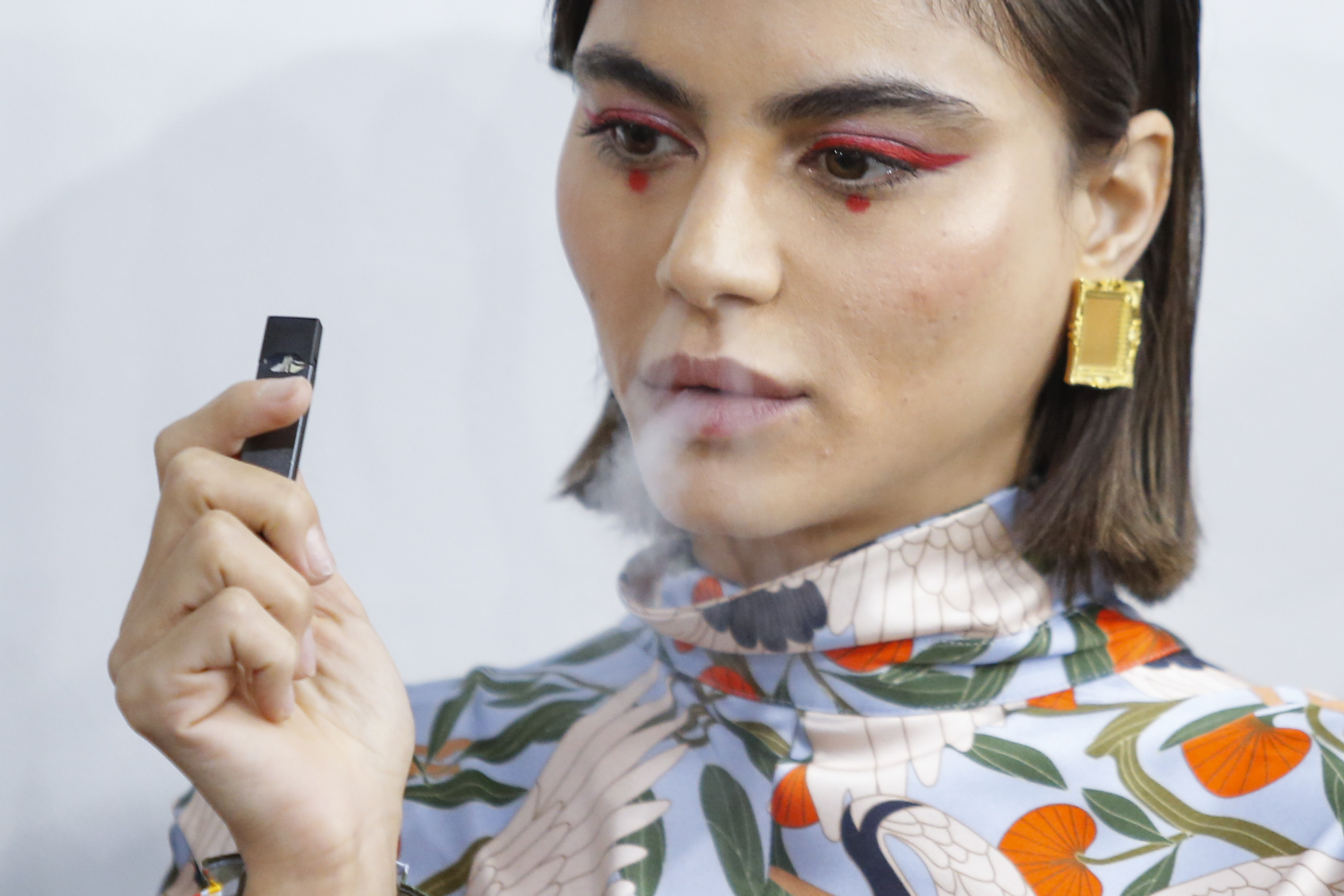 A model smokes a vape before the Snow Xue Gao Spring Summer 2018 show during New York Fashion Week on September 8, 2017 in New York. EDUARDO MUNOZ ALVAREZ/AFP/Getty Images