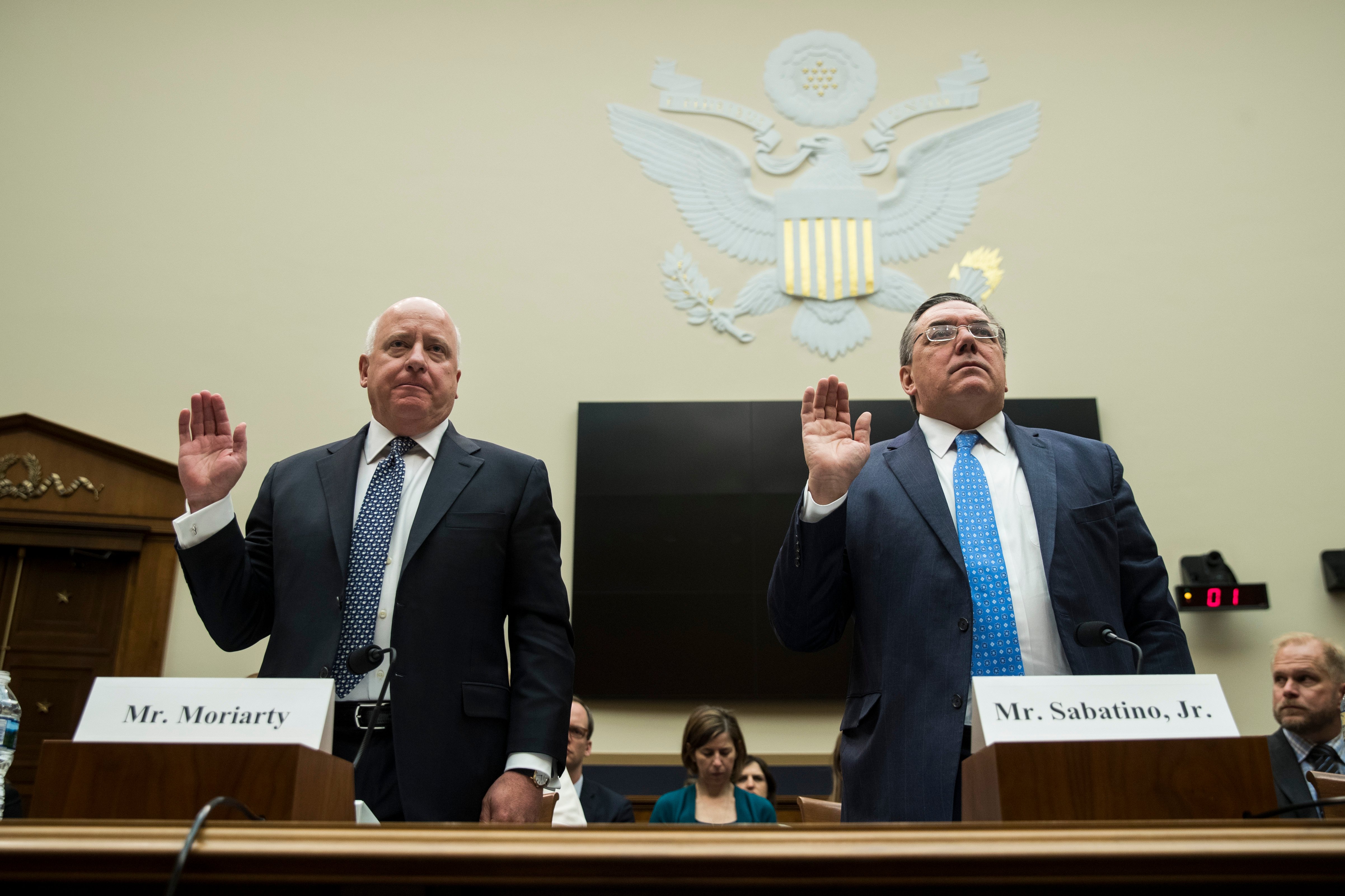(L to R) Thomas Moriarty, executive Vice President and general counsel at CVS Health, and Thomas Sabatino, executive Vice President and general counsel at Aetna, are sworn-in during a House Judiciary Subcommittee hearing on the proposed merger of CVS Health and Aetna, on Capitol Hill, February 27, 2018 in Washington, DC. Drew Angerer/Getty Images