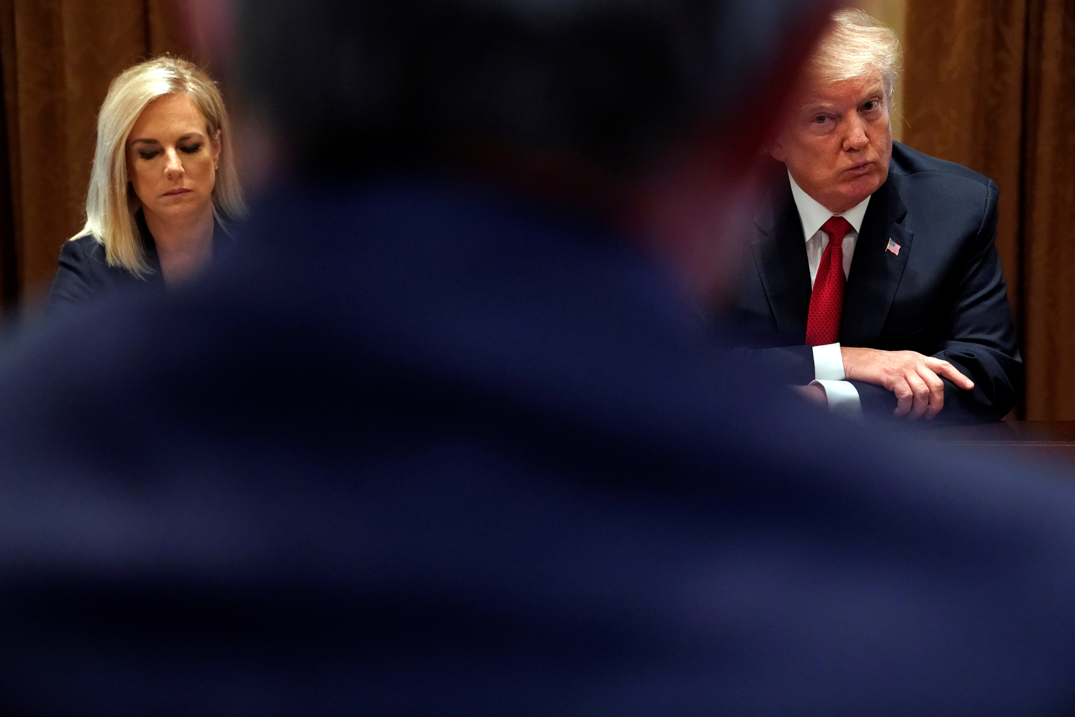 President Donald Trump, flanked by Secretary of Homeland Security Kirstjen Nielsen, meets with members of Congress and U.S. law enforcement about crime and immigration issues, specifically the MS-13 gang, at the White House in Washington, February 6, 2018. REUTERS/Jonathan Ernst