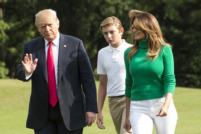 US President Donald Trump (L) walks with First Lady Melania Trump and their son Baron, as they disembark from Marine One on the South Lawn upon his return to the White House after a weekend in Bedminster, in Washington, DC on August 19, 2018. (Photo credit: ERIC BARADAT/AFP/Getty Images)