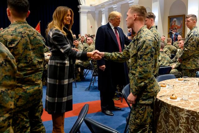 US President Donald Trump (C) and First Lady Melania Trump greet US Marines as they visit the Marine Barracks in Washington DC, on November 15, 2018. - Trump met with Marines who responded to a fire at the Arthur Capper Public Housing complex on September 9, 2018. (Photo credit: JIM WATSON/AFP/Getty Images)
