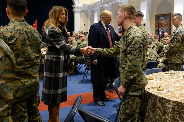 US President Donald Trump (C) and First Lady Melania Trump greet US Marines as they visit the Marine Barracks in Washington DC, on November 15, 2018. - Trump met with Marines who responded to a fire at the Arthur Capper Public Housing complex on September 9, 2018. (Photo credit: JIM WATSON/AFP/Getty Images)