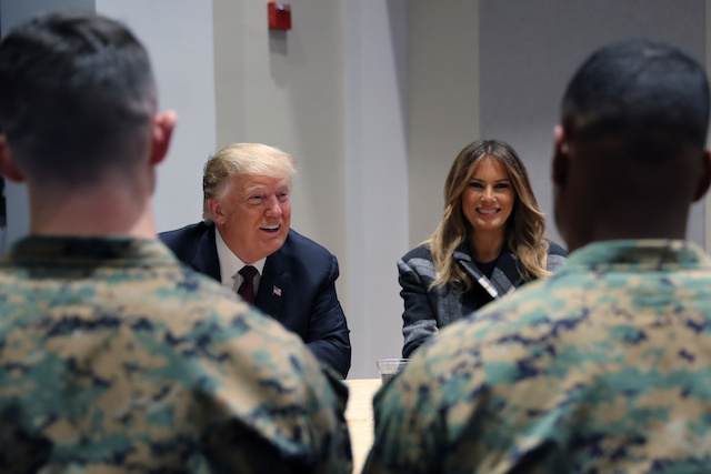 U.S. President Donald Trump speaks next to first lady Melania Trump during a tour of the U.S. Marine Barracks in Washington, U.S., November 15, 2018. REUTERS/Jonathan Ernst