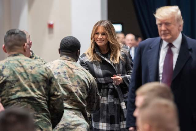 US President Donald Trump (R) and First Lady Melania Trump (C) talk with US Marines as they visits a Marine Barracks in Washington DC, on November 15, 2018, where they met with Marines. - Trump met with Marines who responded to a fire at the Arthur Capper Public Housing complex on September 9, 2018. (Photo credit: JIM WATSON/AFP/Getty Images)