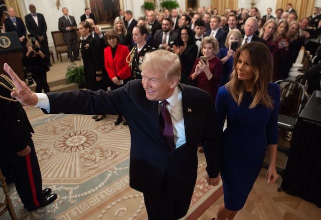 US President Donald Trump and First Lady Melania Trump leave after Trump awarded the Presidential Medal of Freedom during a ceremony in the East Room of the White House in Washington, DC, November 16, 2018. - The Medal is the highest civilian award of the United States. (Photo credit: SAUL LOEB/AFP/Getty Images)