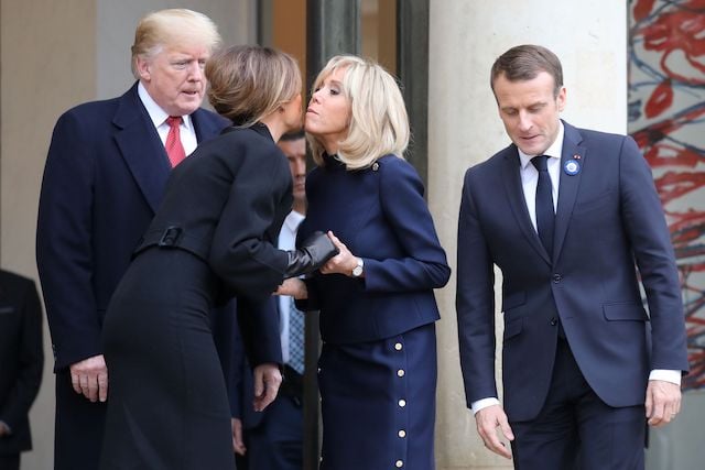 French President Emmanuel Macron (R) and his wife Brigitte Macron (2R) bid farewell to US President Donald Trump and US First Lady Melania Trump as they leave the Elysee Palace in Paris on November 10, 2018 following bilateral talks on the sidelines of commemorations marking the 100th anniversary of the 11 November 1918 armistice, ending World War I. (Photo credit: LUDOVIC MARIN/AFP/Getty Images)