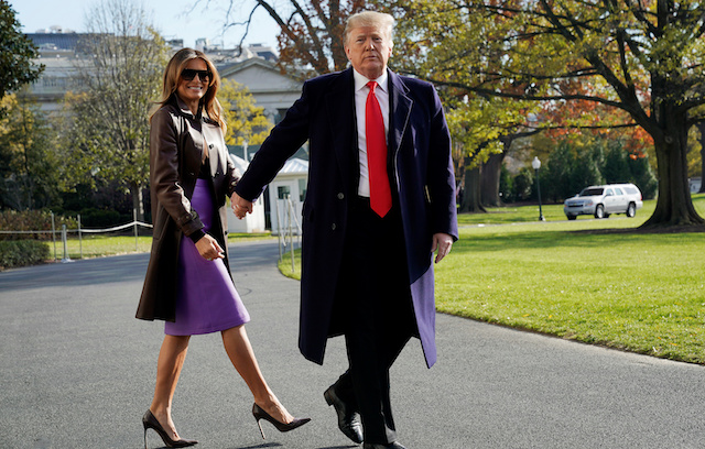 U.S. President Donald Trump walks with first lady Melania Trump as they depart on travel to Argentina from the White House in Washington, U.S., November 29, 2018. REUTERS/Jonathan Ernst