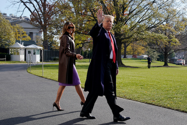U.S. President Donald Trump walks with first lady Melania Trump as they depart for travel to the G-20 summit in Argentina from the White House in Washington, U.S., November 29, 2018. REUTERS/Jonathan Ernst 