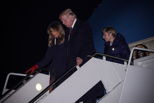 US President Donald Trump (C), First Lady Melania Trump (L) and their son Barron disembark from Air Force One upon their arrival at Joint Base Andrews near Washington on November 25, 2018. - Trump is returning to Washington after spending the Thanksgiving holiday at his Mar-a-Lago resort. (Photo credit: MANDEL NGAN/AFP/Getty Images)