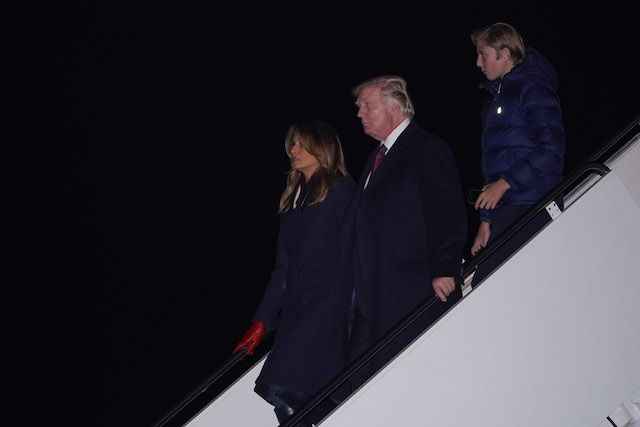 US President Donald Trump (C), First Lady Melania Trump (L) and their son Barron disembark from Air Force One upon their arrival at Joint Base Andrews near Washington on November 25, 2018. - Trump is returning to Washington after spending the Thanksgiving holiday at his Mar-a-Lago resort. (Photo credit: MANDEL NGAN/AFP/Getty Images)