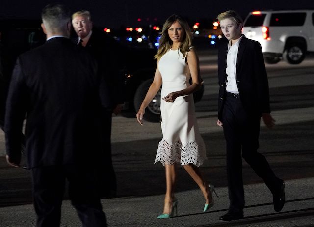 US President Donald Trump, First Lady Melania Trump and their son Barron step off Air Force One upon arrival at Palm Beach International Airport in West Palm Beach, Florida on November 20, 2018. - Trump will be spending the Thanksgiving holiday at his Mar-a-Lago resort. (Photo credit: MANDEL NGAN/AFP/Getty Images)