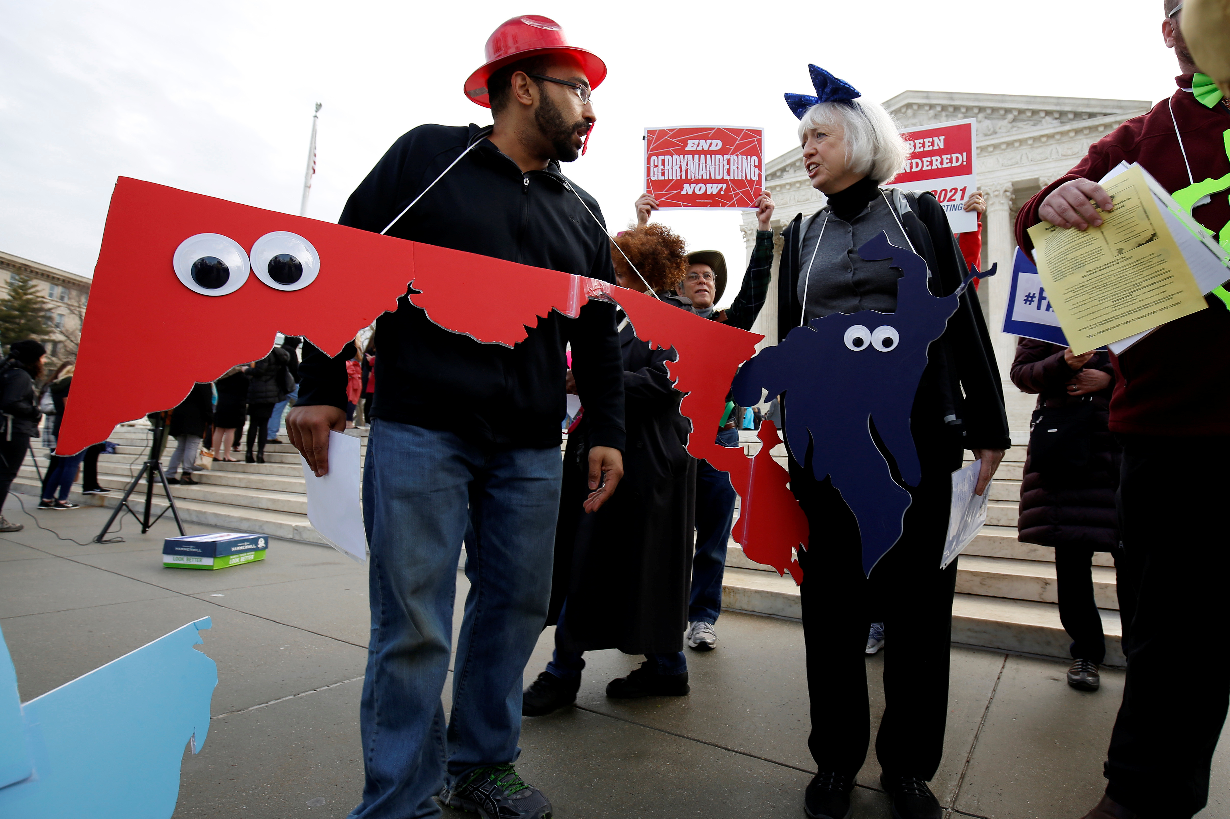 Demonstrators rally with cut-outs of congressional districts in front of the Supreme court before oral arguments on Benisek v. Lamone, a redistricting case on whether Democratic lawmakers in Maryland unlawfully drew a congressional district in a way that would prevent a Republican candidate from winning, in Washington, U.S., March 28, 2018. REUTERS/Joshua Roberts