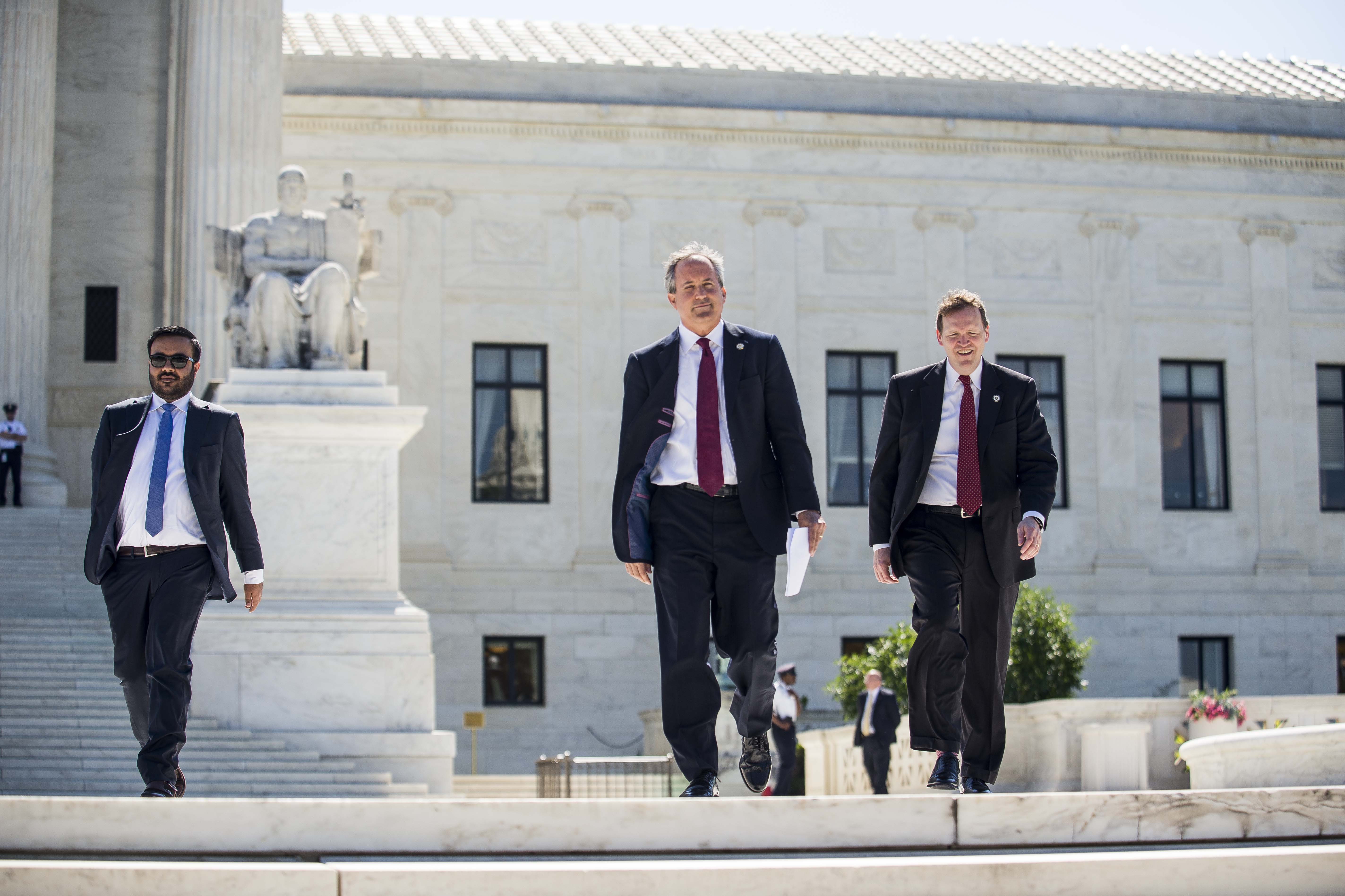 Texas Attorney General Ken Paxton (C) walks to a news conference outside the Supreme Court on Capitol Hill on June 9, 2016 in Washington, D.C. Paxton announced a lawsuit against the state of Delaware over unclaimed checks. (Gabriella Demczuk/Getty Images)