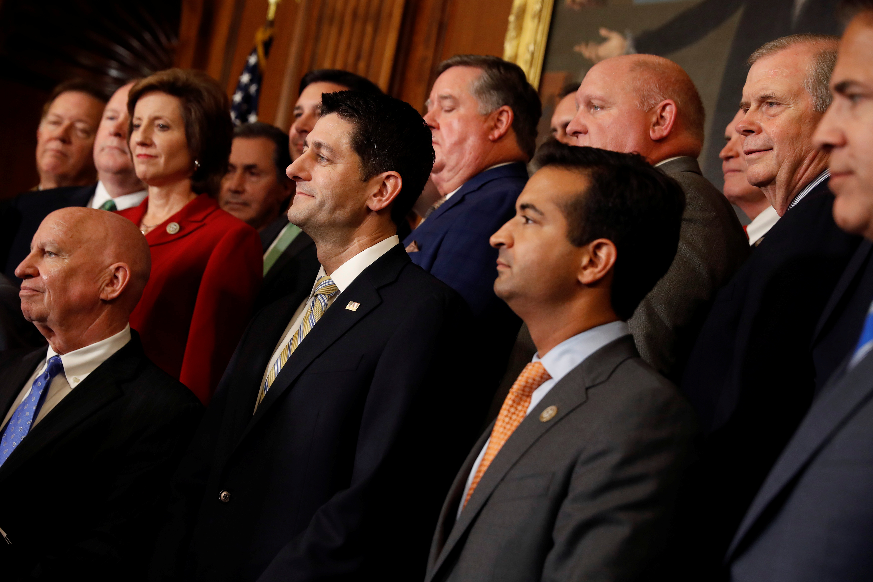 Rep. Kevin Brady (R-TX), Speaker of the House Paul Ryan and Rep. Carlos Curbelo (R-FL) look on during a news conference announcing the passage of the "Tax Cuts and Jobs Act" at the U.S. Capitol in Washington