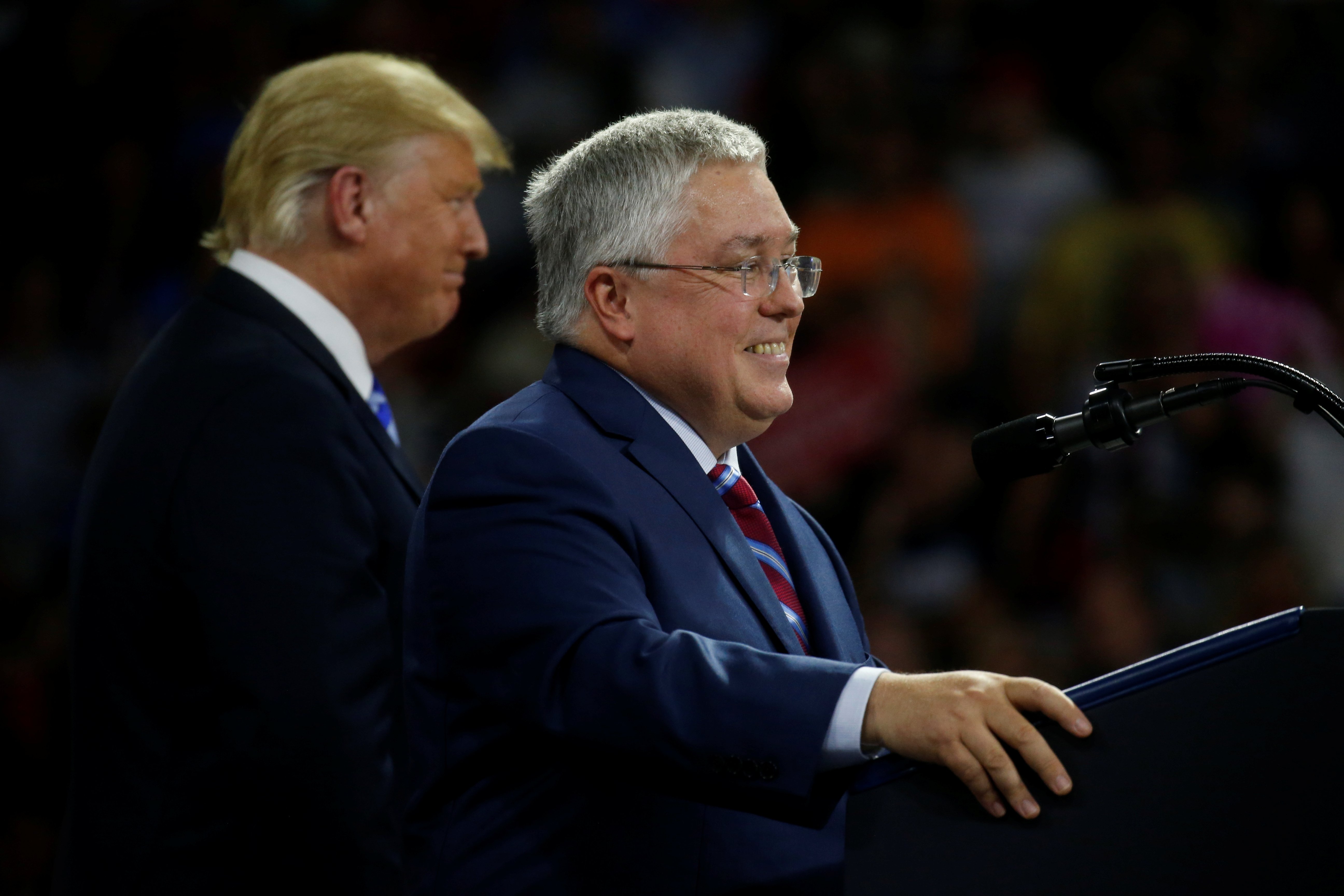 Patrick Morrisey, Attorney General of West Virginia speaks as U.S. President Donald Trump looks on at a Make America Great Again rally at the Civic Center in Charleston