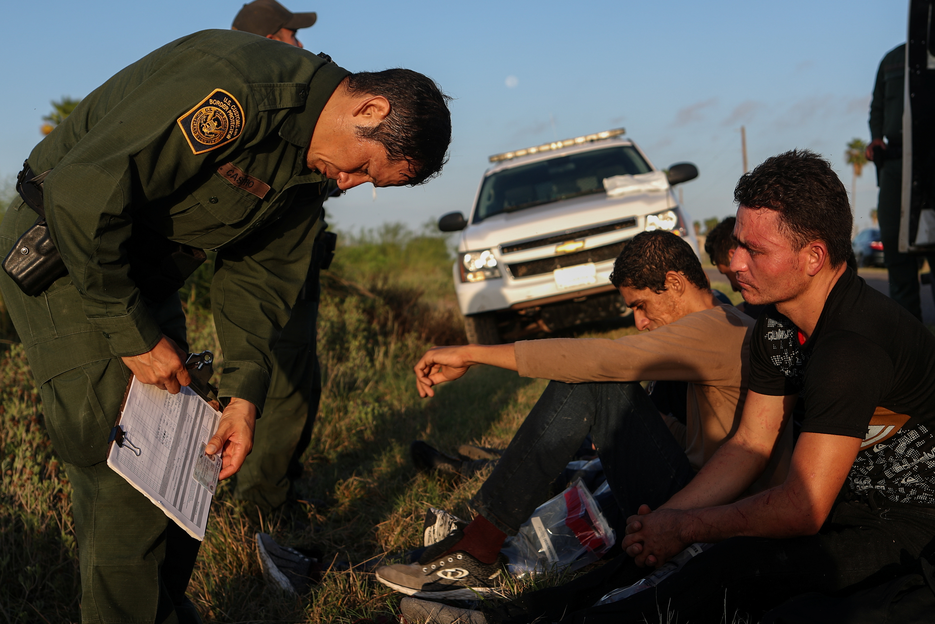 Men from El Salvador are apprehended by the border patrol after they illegally crossed into the United States from Mexico in La Joya, Texas