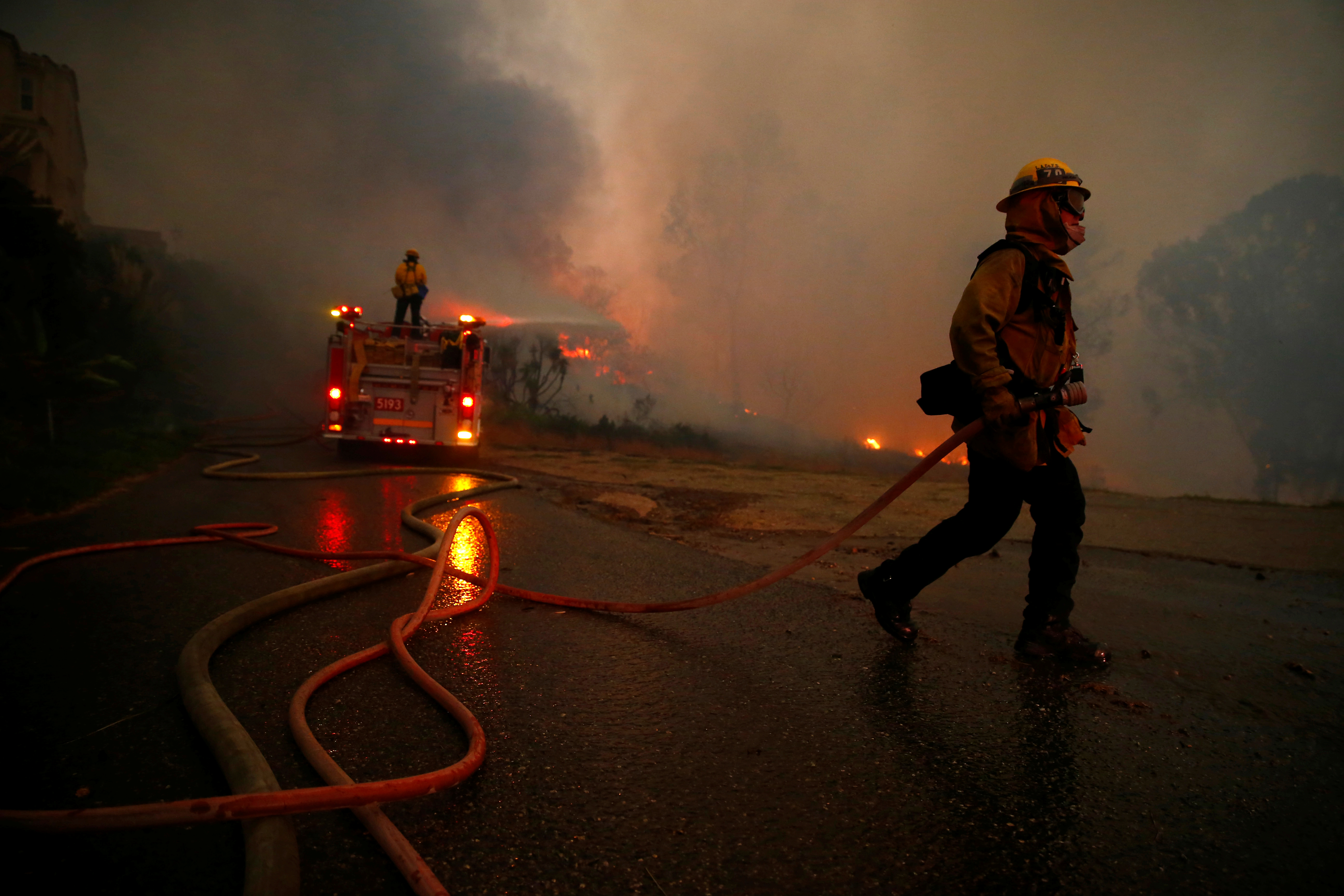 Firefighters battle the Woolsey Fire in Malibu