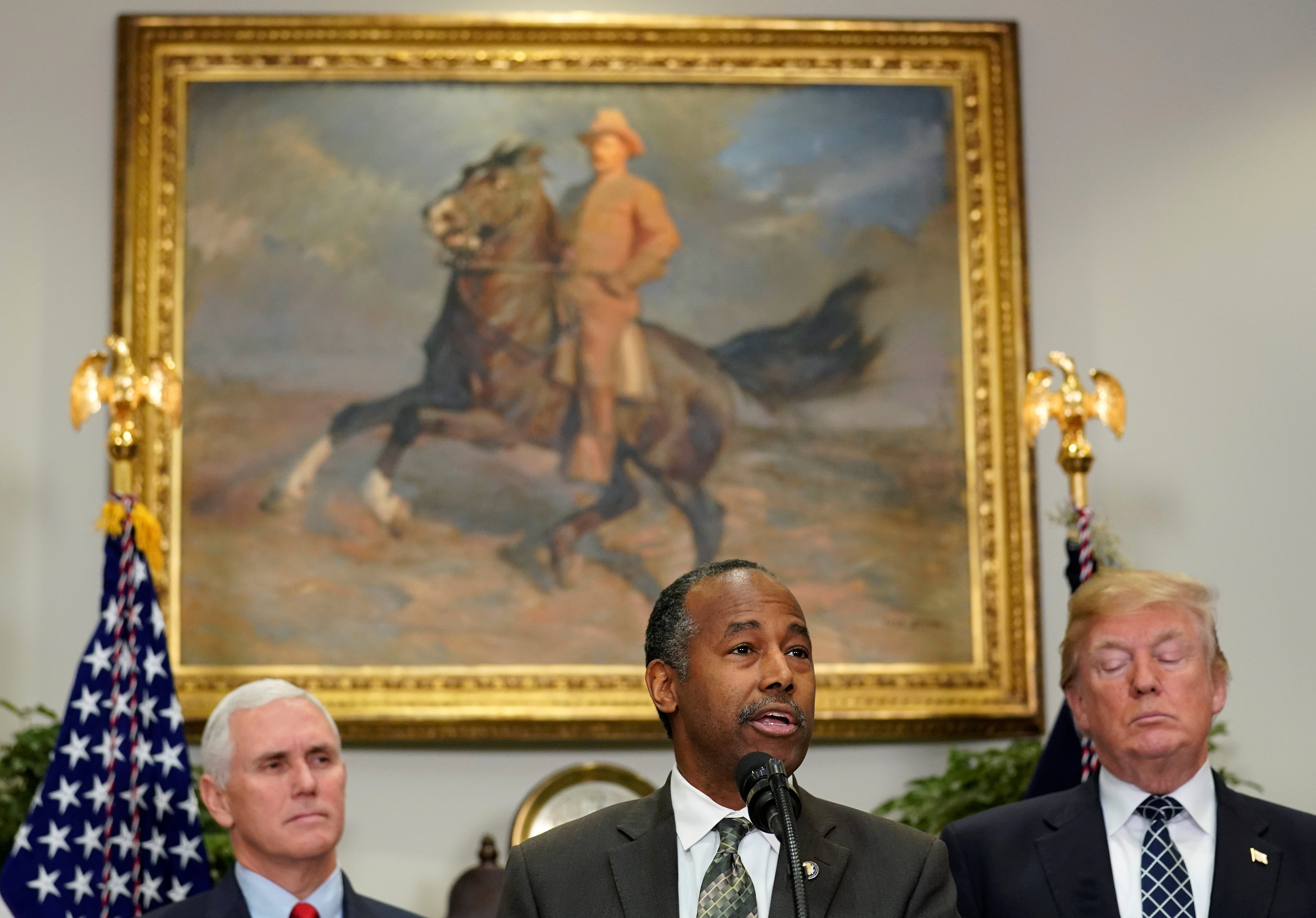 U.S. Secretary of Housing and Urban Development Ben Carson speaks as U.S. Vice President Mike Pence and U.S. President Donald Trump watch during an event to honor Martin Luther King Jr. in the Roosevelt Room of the White House in Washington, U.S., January 12, 2018. REUTERS/Joshua Roberts - RC15FB189000