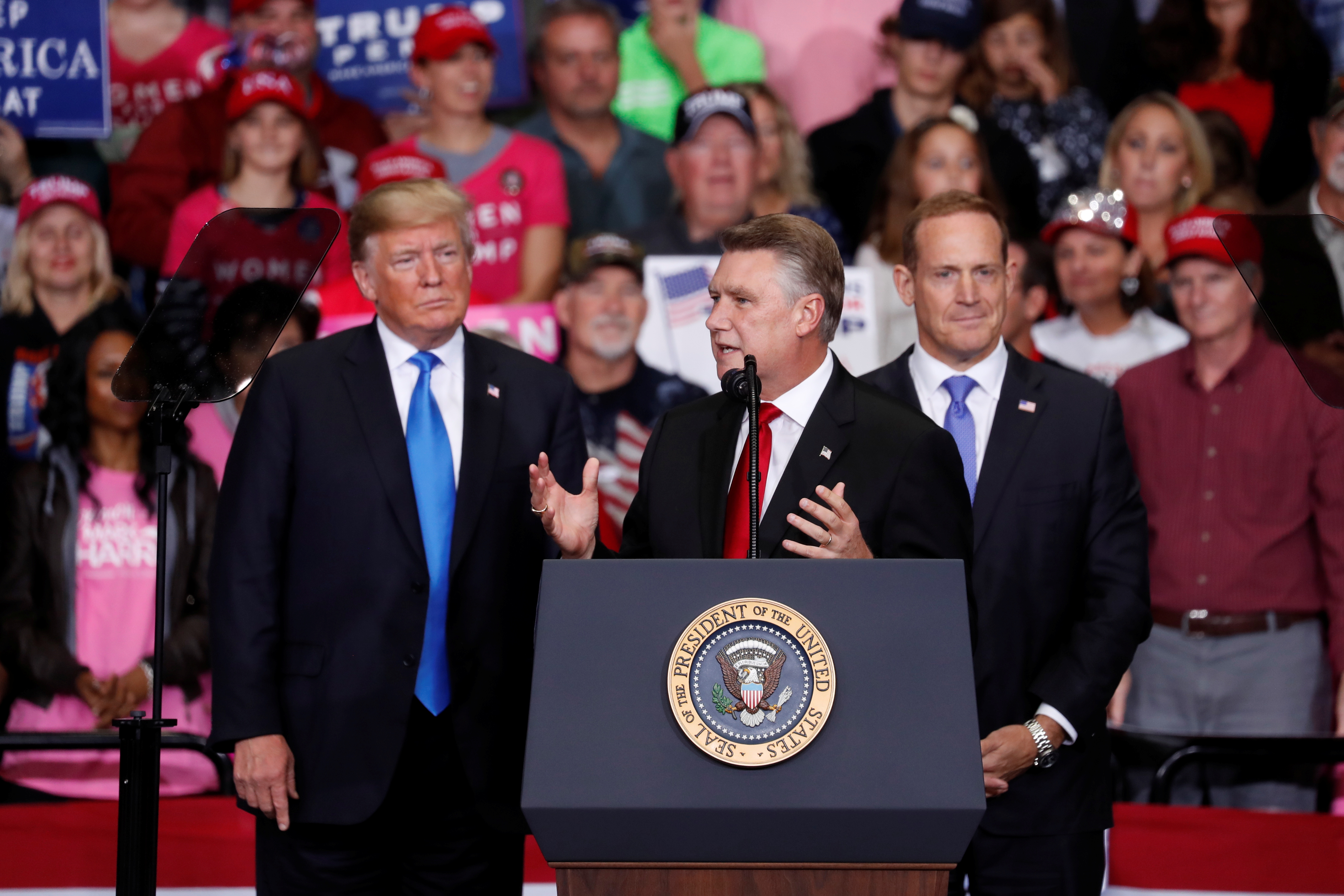 Harris, Republican candidate from North Carolina's 9th Congressional district speaks as U.S. President Trump looks on during a campaign rally in Charlotte