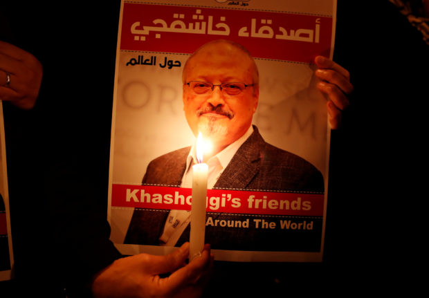 A demonstrator holds a poster with a picture of Saudi journalist Jamal Khashoggi outside the Saudi Arabia consulate in Istanbul, Turkey October 25, 2018. REUTERS/Osman Orsal