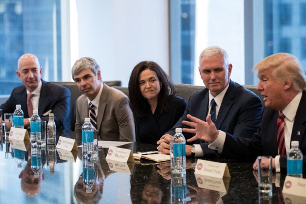 NEW YORK, NY - DECEMBER 14: (L to R) Jeff Bezos, chief executive officer of Amazon, Larry Page, chief executive officer of Alphabet Inc. (parent company of Google), Sheryl Sandberg, chief operating officer of Facebook, Vice President-elect Mike Pence listen as President-elect Donald Trump speaks during a meeting of technology executives at Trump Tower, December 14, 2016 in New York City. This is the first major meeting between President-elect Trump and technology industry leaders. (Photo by Drew Angerer/Getty Images)
