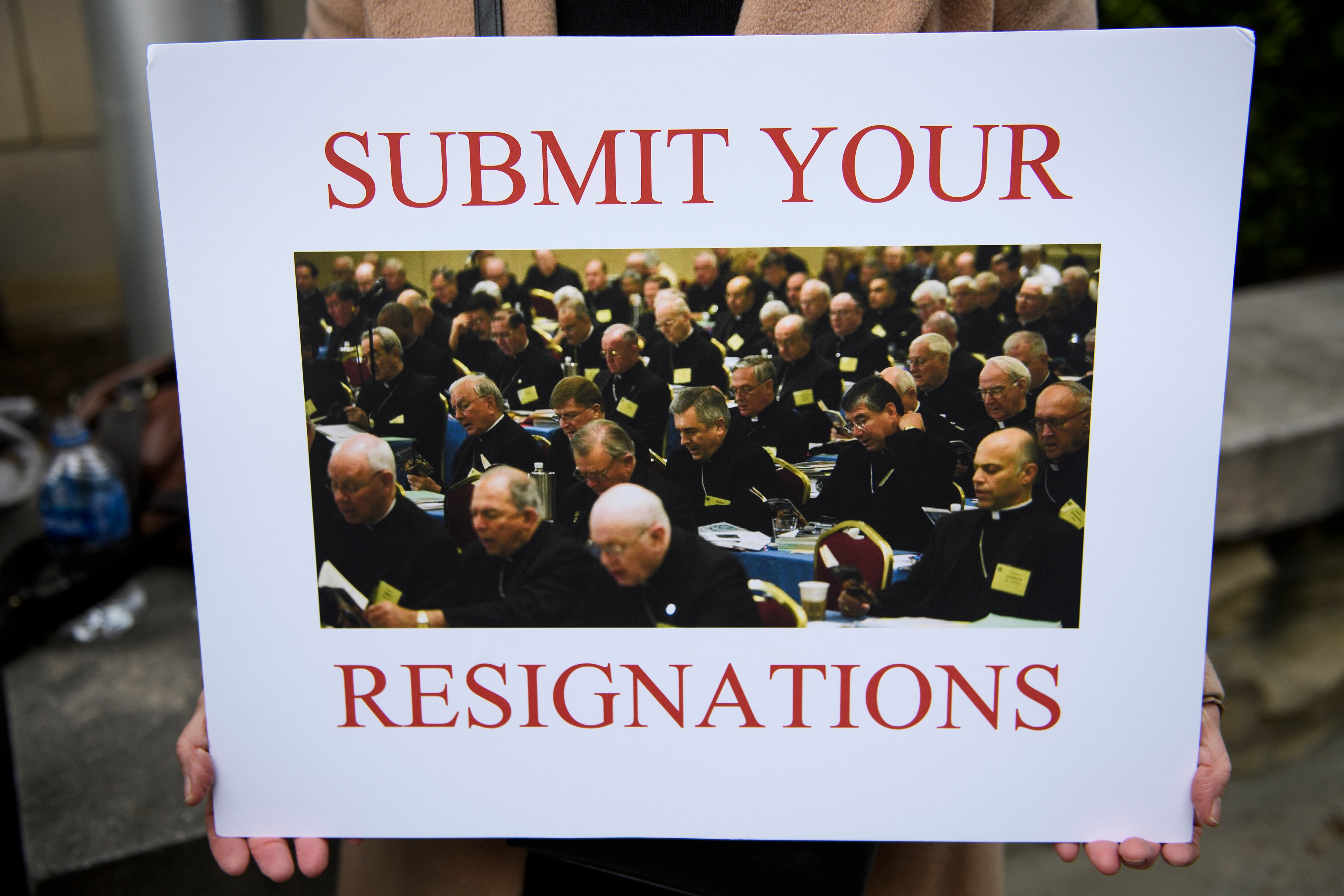 A protester holds a sign during the annual US Conference of Catholic Bishops November 12, 2018 in Baltimore, Maryland. ( BRENDAN SMIALOWSKI/AFP/Getty Images)