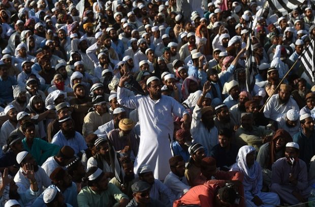 Supporters of the Pakistani religious Islamist group Mutahida Majlis-e-Amal (MMA) gather during a protest rally against the release of Asia Bibi, a Christian woman who was charged with blasphemy, in Karachi on November 8, 2018. - A Pakistani Christian woman who spent eight years on death row for blasphemy has been freed from jail after an acquittal that triggered Islamist protests, but is still in Pakistan, officials said on November 8 amid appeals for her to be offered asylum. (Photo by ASIF HASSAN / AFP) 