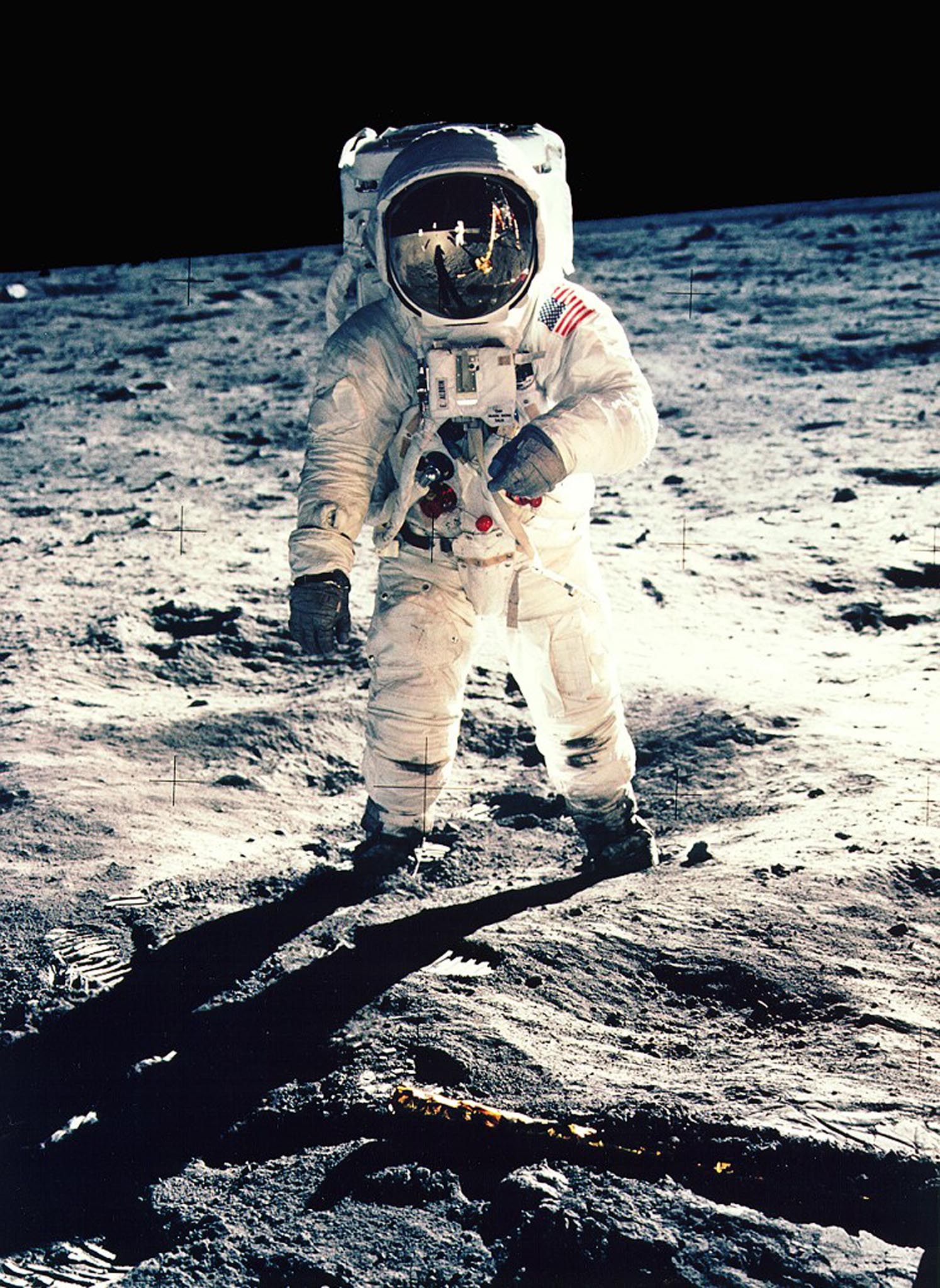 - FILE PHOTO JULY 1969 - Astronaut Edwin F. "Buzz" Aldrin Jr., lunar module pilot, faces the camera as he walks on the Moon during Apollo 11 extra vehicular activity in this file photograph. The plexiglass of his helmet reflects back the scene in front of him, such as the Lunar Module and Astronaut Neil Armstrong, taking his picture. Armstrong, Apollo 11 commander, took this photograph with a 70mm lunar surface camera. The 30th anniversary of the Apollo 11 mission is July 16 (launch) and July 20 (landing on the moon).