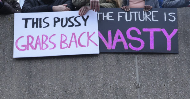 TORONTO- JANUARY 21: Girls holding sign mocking Trump's "pussy and nasty " comments during the "Women's March on Washington" to protest against Trump presidency on January 21, 2017 in Toronto, Canada.