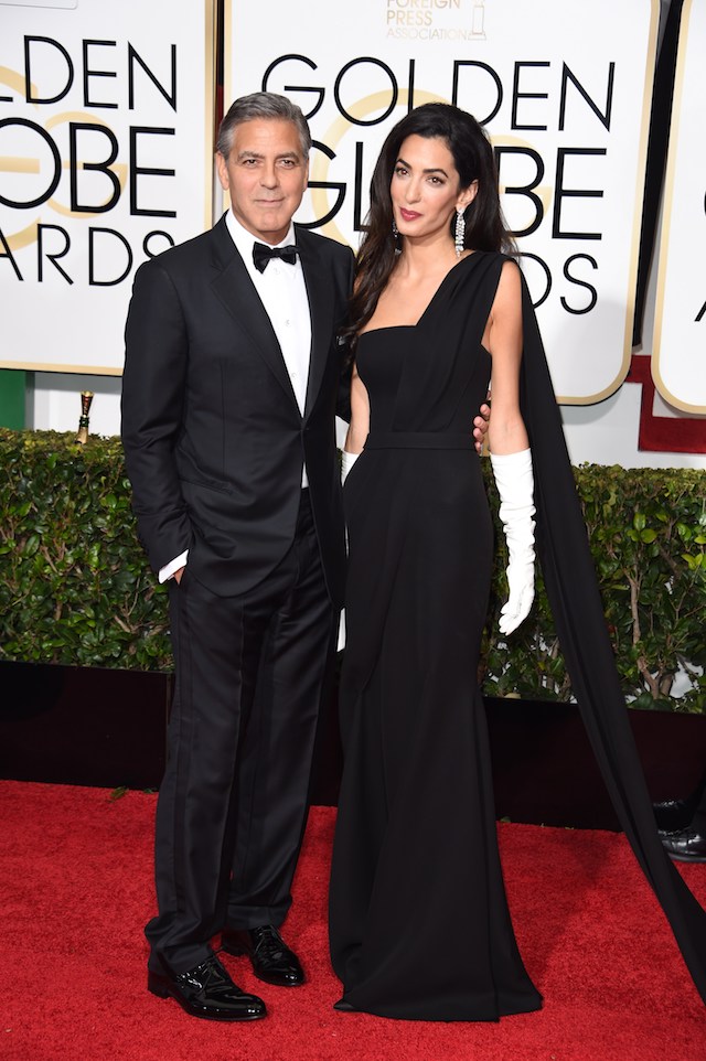Actor George Clooney (L) and Amal Clooney arrive on the red carpet for the 72nd annual Golden Globe Awards, January 11, 2015 at the Beverly Hilton Hotel in Beverly Hills, California. (Photo credit: MARK RALSTON/AFP/Getty Images)