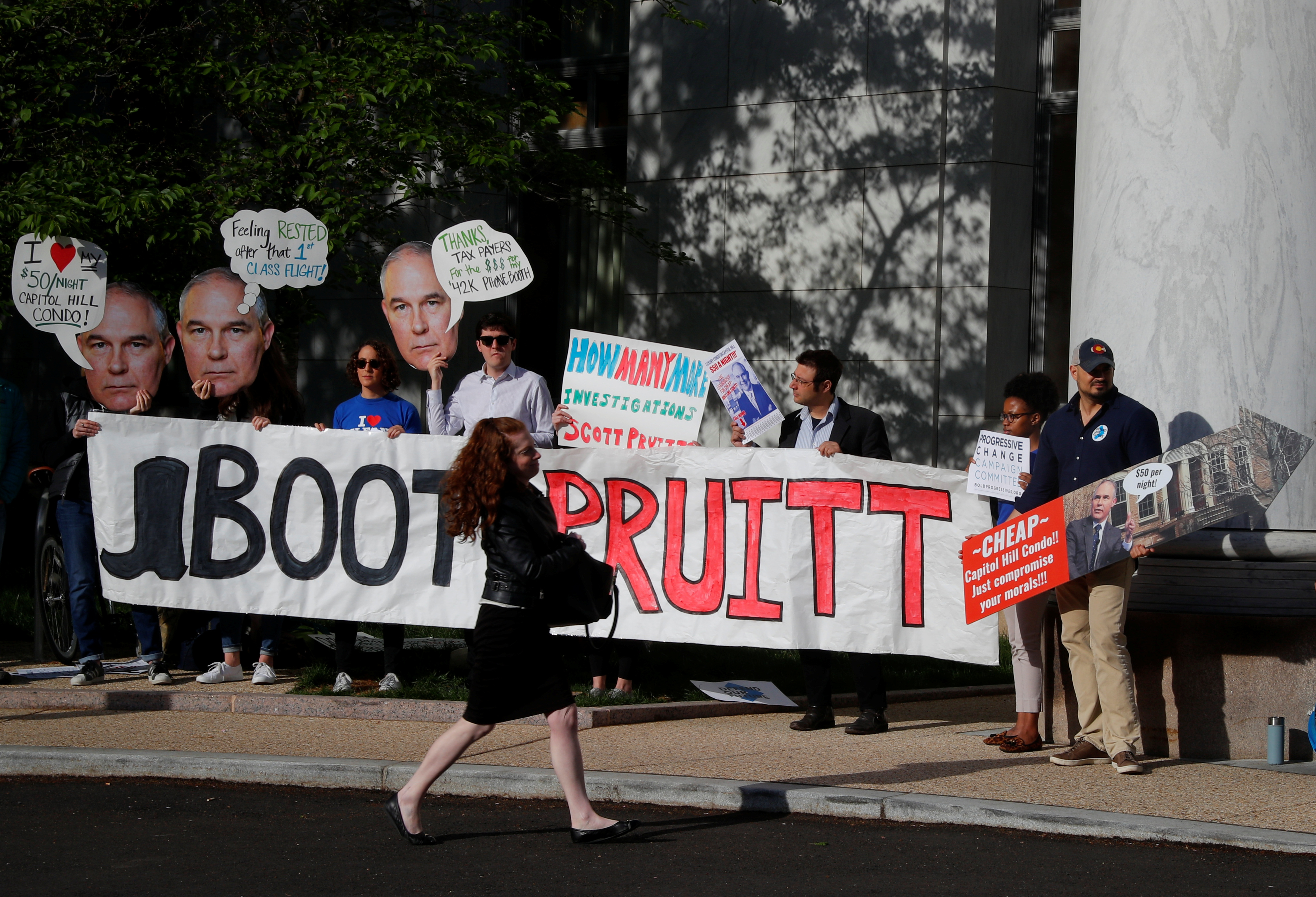 People protest before EPA Administrator Scott Pruitt testifies before a House Energy and Commerce Subcommittee hearing on the FY2019 Environmental Protection Agency budget in Washington, U.S., April 26, 2018. REUTERS/Brian Snyder