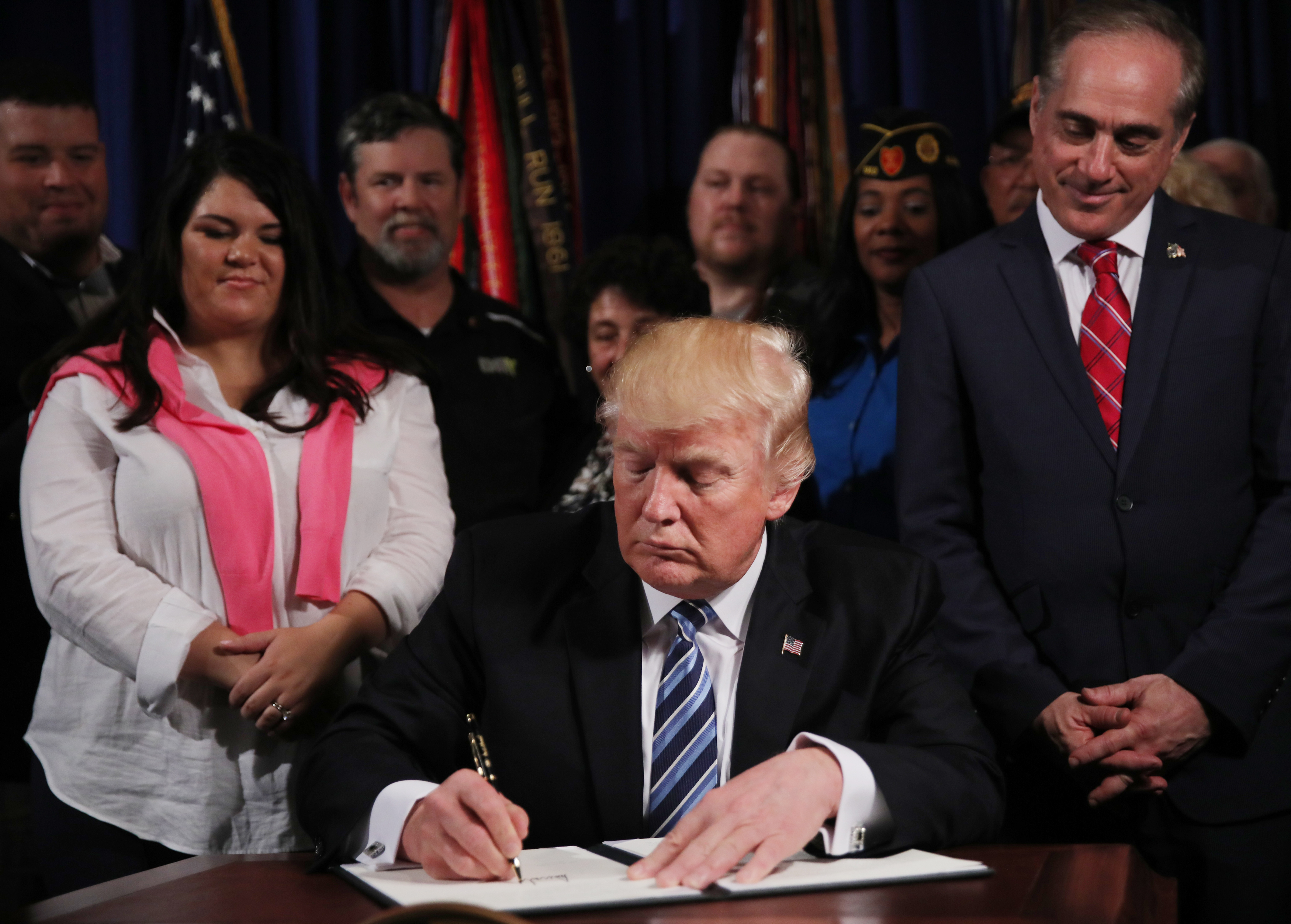 President Donald Trump signs an Executive Order on improving accountability and whistleblower protection at the Veterans Affairs Department in Washington, April 27, 2017. REUTERS/Carlos Barria