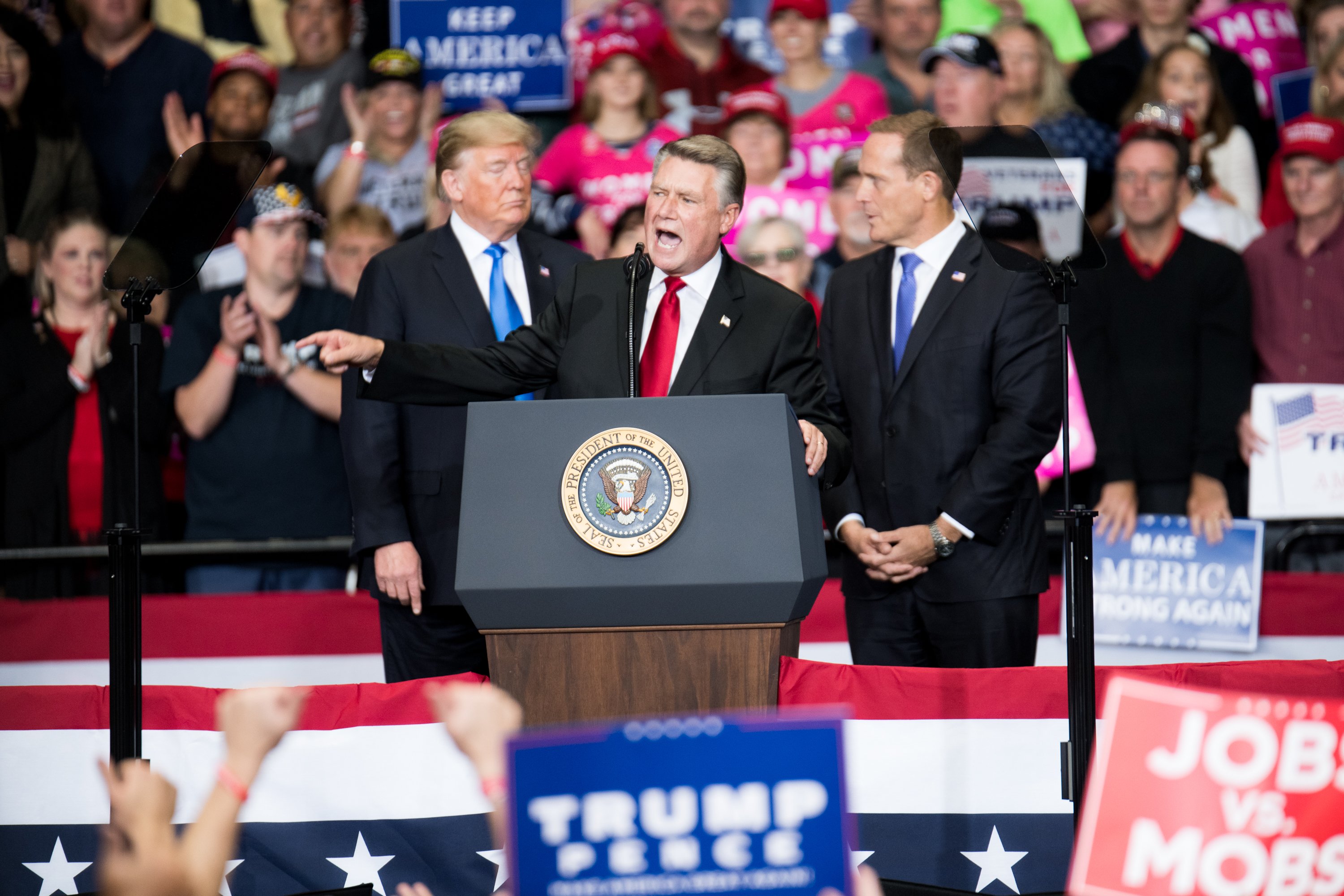 Republican Congressional candidate for North Carolina's 9th district Mark Harris (C), addresses the crowd as President Donald Trump (L) and Republican Congressional candidate for North Carolina's 13th district Ted Budd (R), listen at the Bojangles Coliseum on October 26, 2018 in Charlotte, North Carolina. (Photo by Sean Rayford/Getty Images)