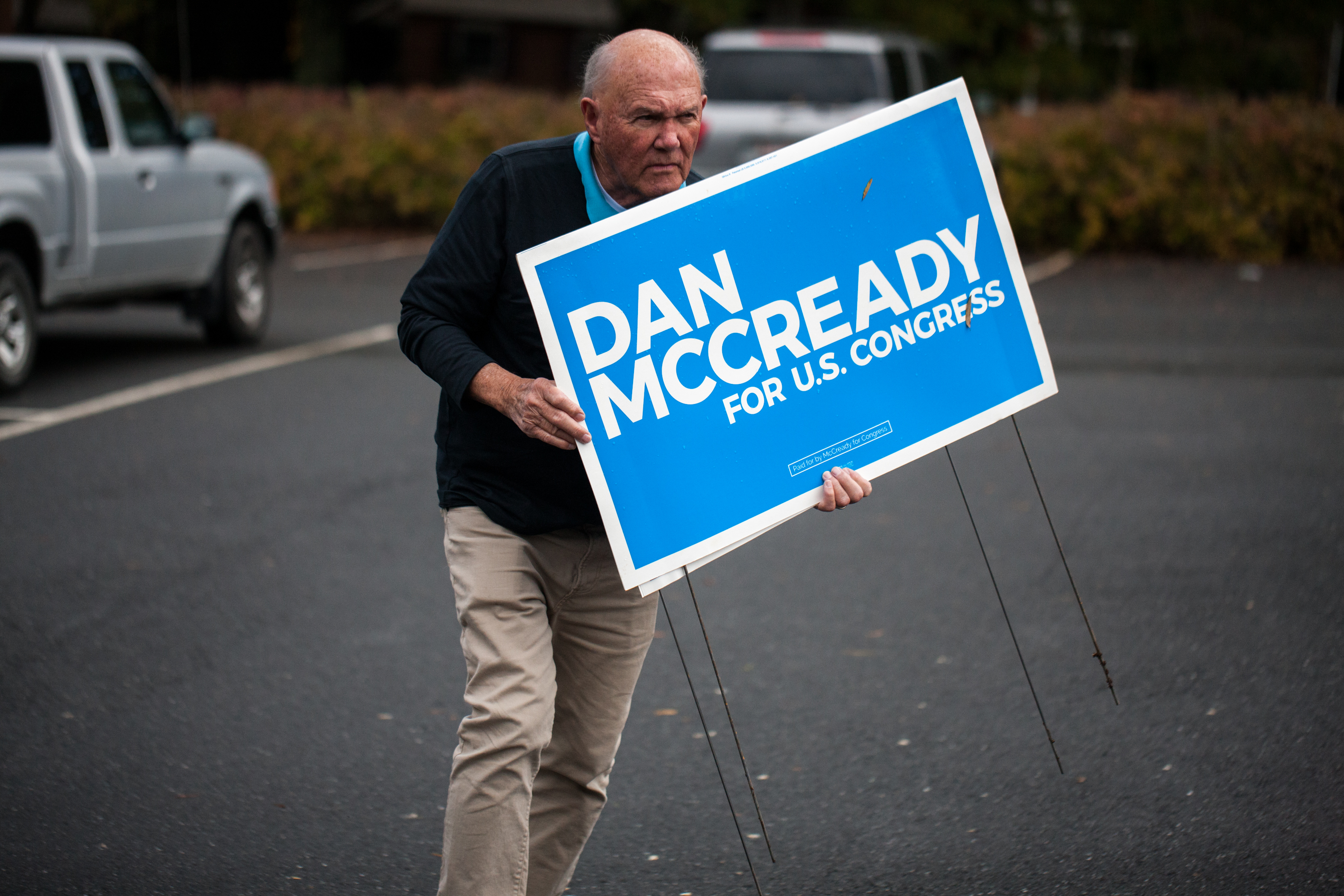 A campaign volunteer for Democratic US House candidate, Dan McCready, carries signs on November 6, 2018 in Charlotte, North Carolina. (LOGAN CYRUS/AFP/Getty Images)