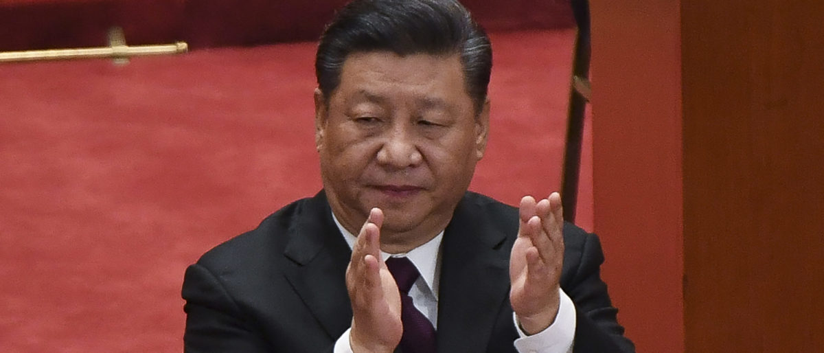 China's President Xi Jinping applauds during a celebration meeting marking the 40th anniversary of China's "reform and opening up" policy at the Great Hall of the People in Beijing on December 18, 2018. (WANG ZHAO/AFP/Getty Images)
