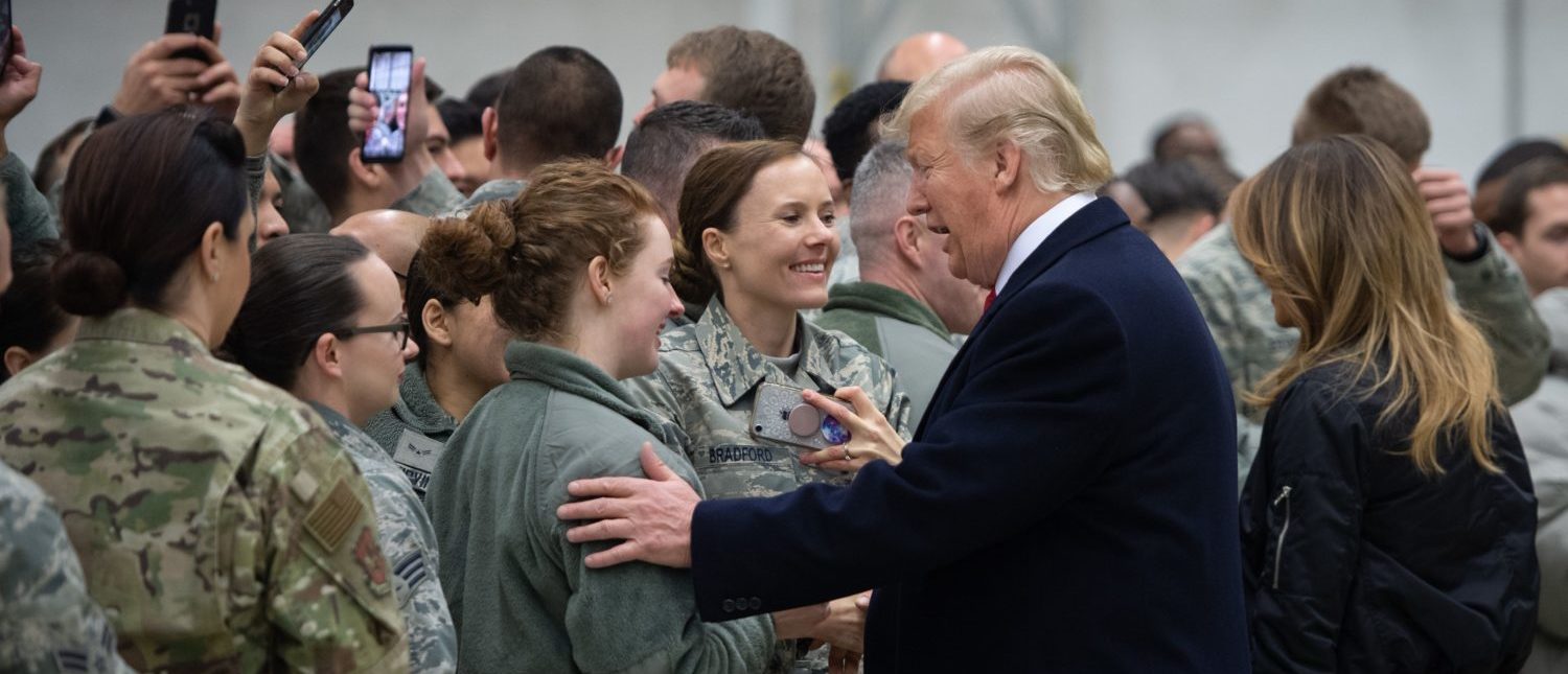US President Donald Trump and First Lady Melania Trump greet members of the US military during a stop at Ramstein Air Base in Germany, on December 27, 2018. - President Donald Trump used a lightning visit to Iraq -- his first with US troops in a conflict zone since being elected -- to defend the withdrawal from Syria and to declare an end to America's role as the global "policeman." (Photo by SAUL LOEB/AFP/Getty Images)