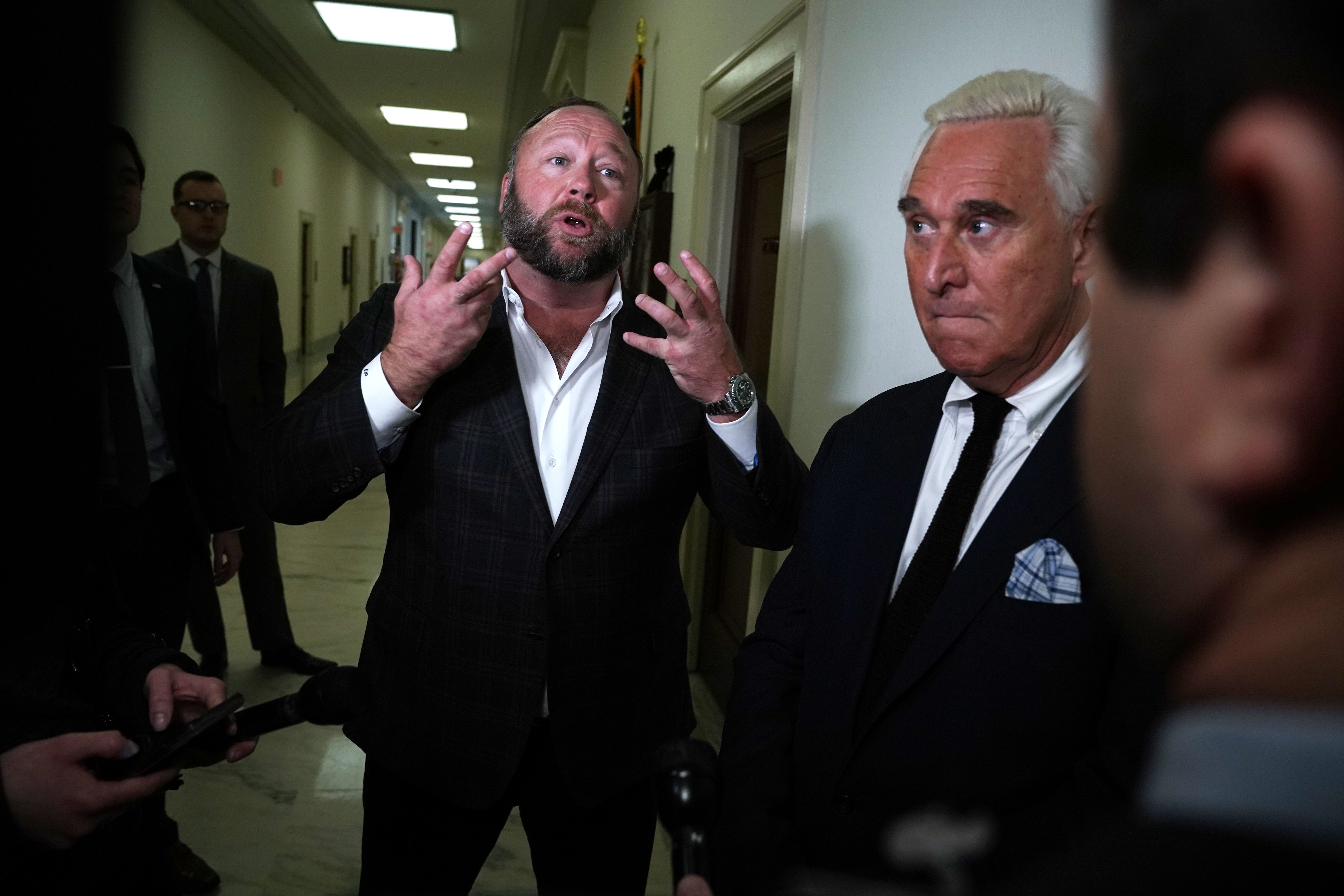 WASHINGTON, DC - DECEMBER 11: Longtime informal adviser to President Trump Roger Stone (R) and Alex Jones (L) of Infowars speak to cameras outside a hearing where Google CEO Sundar Pichai testified before the House Judiciary Committee at the Rayburn House Office Building on December 11, 2018 in Washington, DC. The committee held a hearing on 'Transparency & Accountability: Examining Google and its Data Collection, Use and Filtering Practices.” (Photo by Alex Wong/Getty Images)