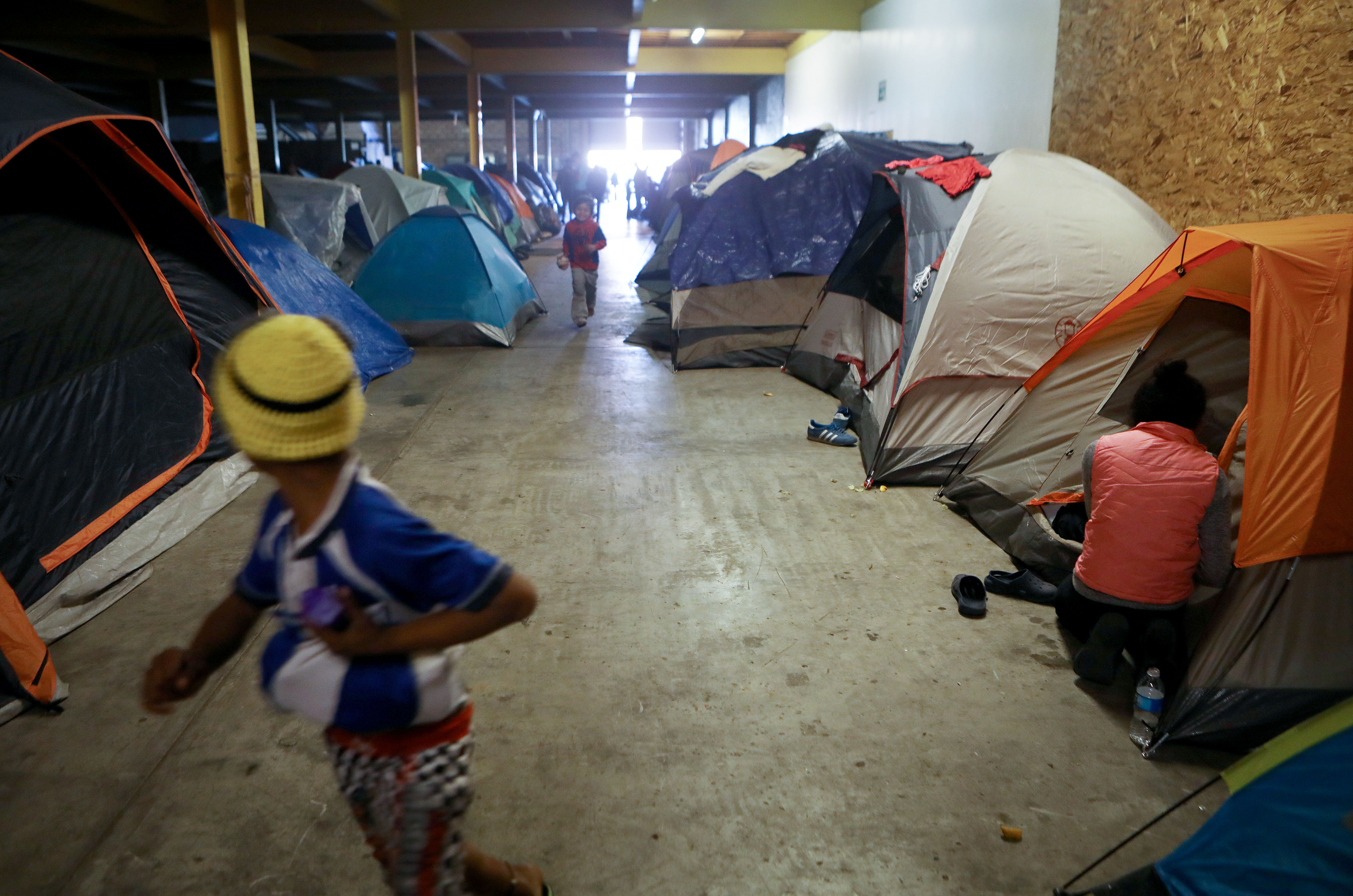 TIJUANA, MEXICO - DECEMBER 16: Migrants gather in the third shelter opened to migrants in Tijuana weeks after thousands from the 'migrant caravan' arrived in the border city on December 16, 2018 in Tijuana, Mexico. (Photo by Mario Tama/Getty Images)