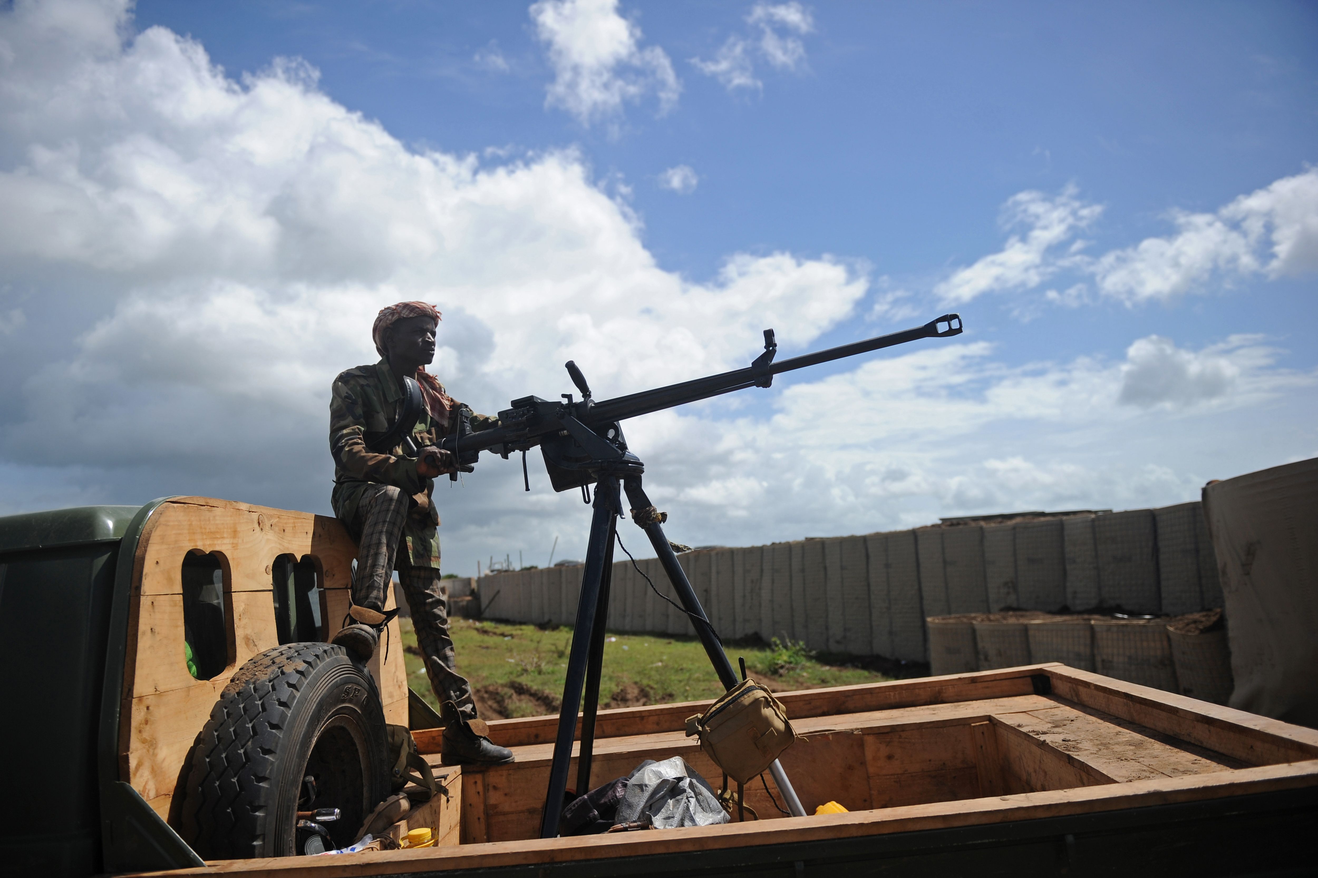 A Somali soldier holds a machine gun at Sanguuni military base, where an American special operations soldier was killed by a mortar attack on June 8, about 450 km south of Mogadishu, Somalia, on June 13, 2018. - More than 500 American forces are partnering with African Union Mission to Somalia (AMISOM) and Somali national security forces in counterterrorism operations, and have conducted frequent raids and drone strikes on Al-Shabaab training camps throughout Somalia. (Photo by MOHAMED ABDIWAHAB/AFP/Getty Images)