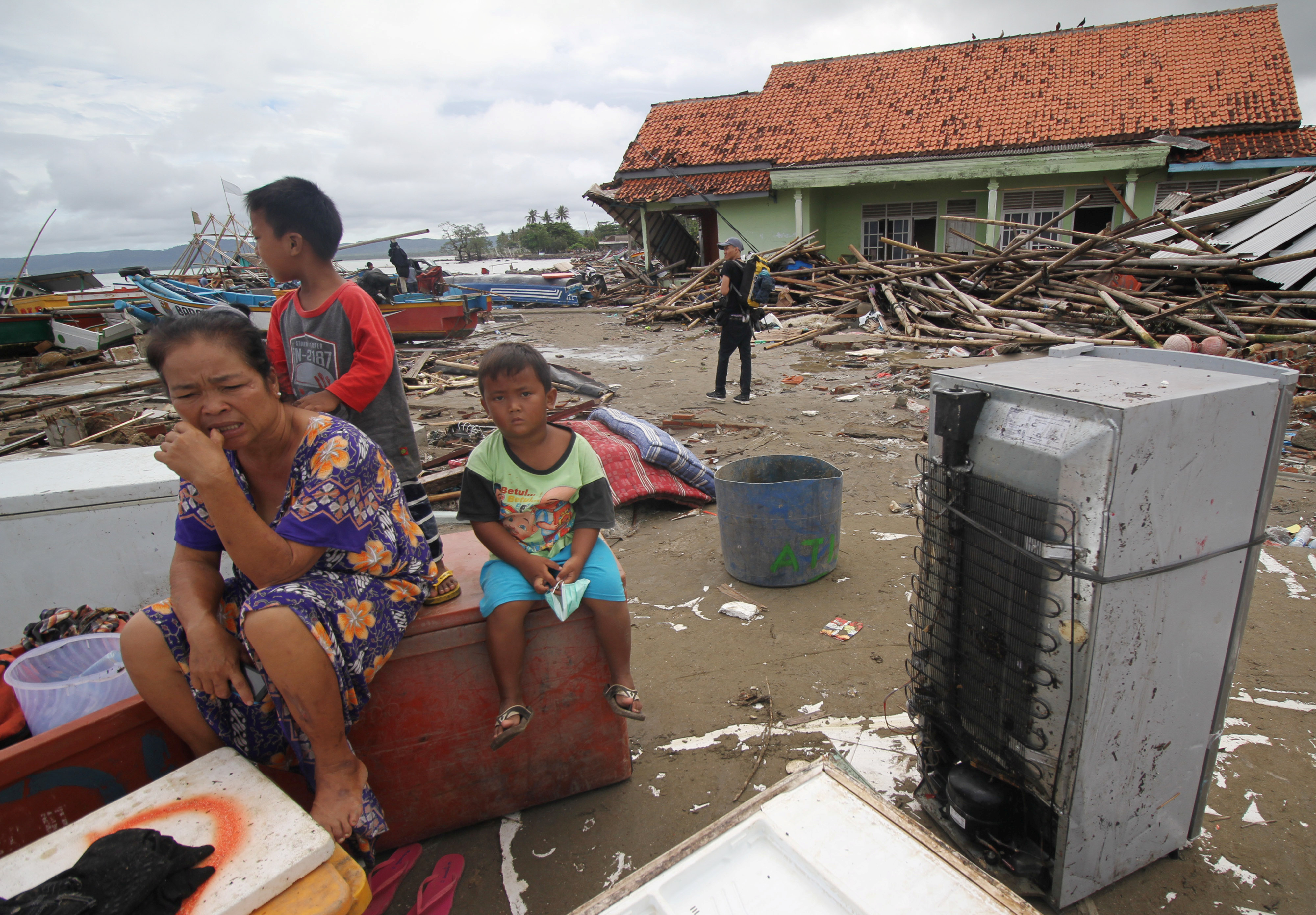 Local residents sit among their items after a tsunami hit at Sumur district in Pandeglang, Banten province, Indonesia, December 24, 2018. Antara Foto/Aurora Rinjani/ via REUTERS