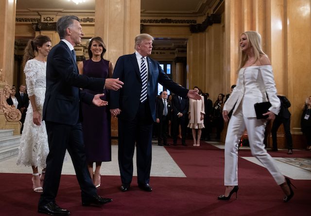 US President Donald Trump (C) calls her daughter White House adviser Ivanka Trump to join her wife US First Lady Melania Trump (3-L), Argentina's President Mauricio Macri (2-L) and his wife Argentina's First Lady Juliana Awada (L), prior to a gala at the Colon Theater in Buenos Aires, on November 30, 2018 in the sidelines of the G20 Leader's Summit. (Photo credit: SAUL LOEB/AFP/Getty Images)