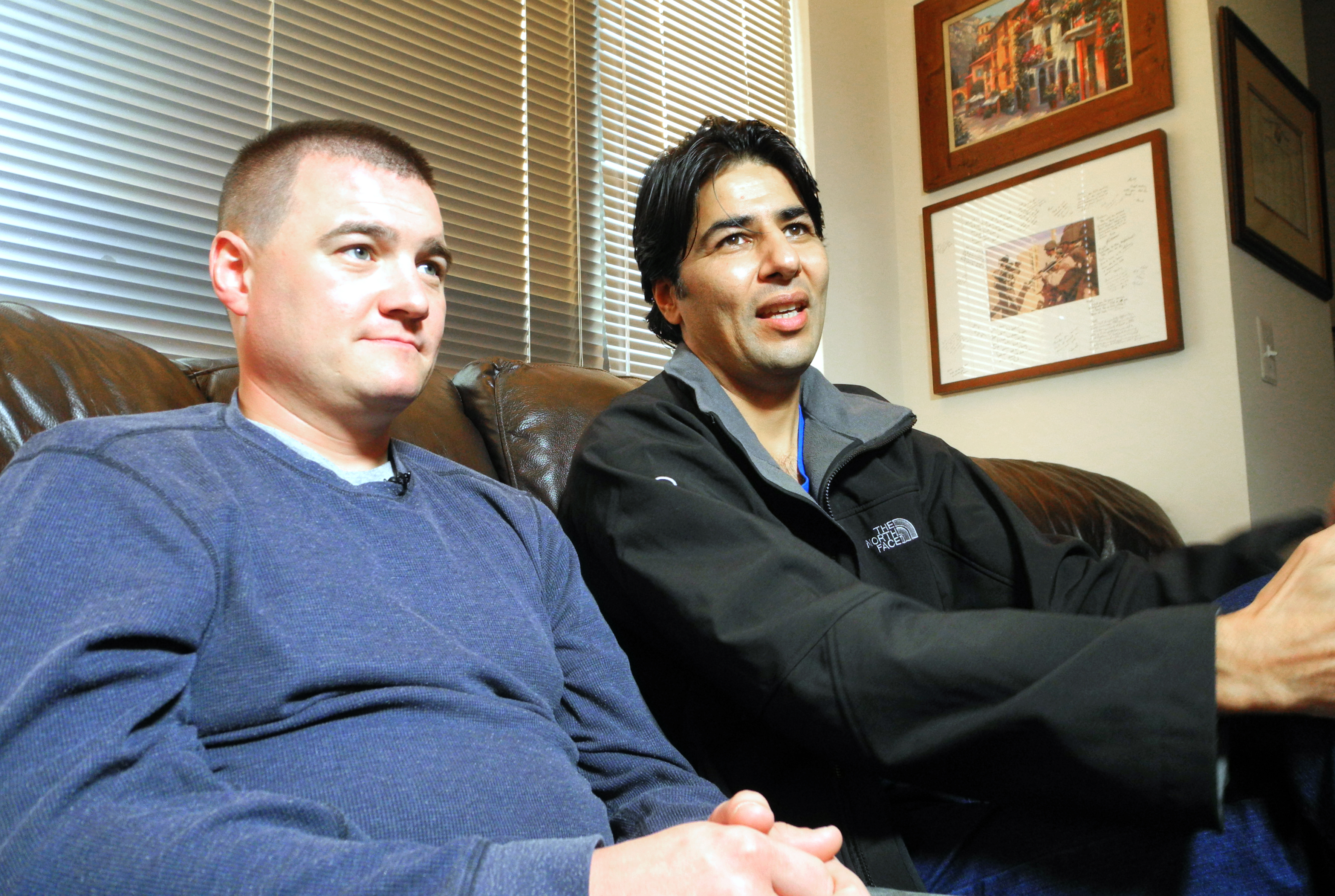 U.S. Army Captain Matt Zeller (L) with translator Janis Shenwari, whom he credits for saving his life in a firefight in Afghanistan in November 2008, and who, after 5 years of struggle, is one of the lucky few who was able to take advantage of the special Visa program for Afghanistan interpreters.(Guillaume Meyer/AFP/Getty Images)