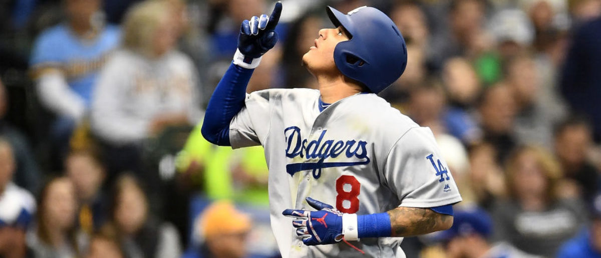 MILWAUKEE, WI - OCTOBER 12: Manny Machado #8 of the Los Angeles Dodgers celebrates after hitting a solo home run against Gio Gonzalez #47 of the Milwaukee Brewers during the second inning in Game One of the National League Championship Series at Miller Park on October 12, 2018 in Milwaukee, Wisconsin. (Photo by Stacy Revere/Getty Images)