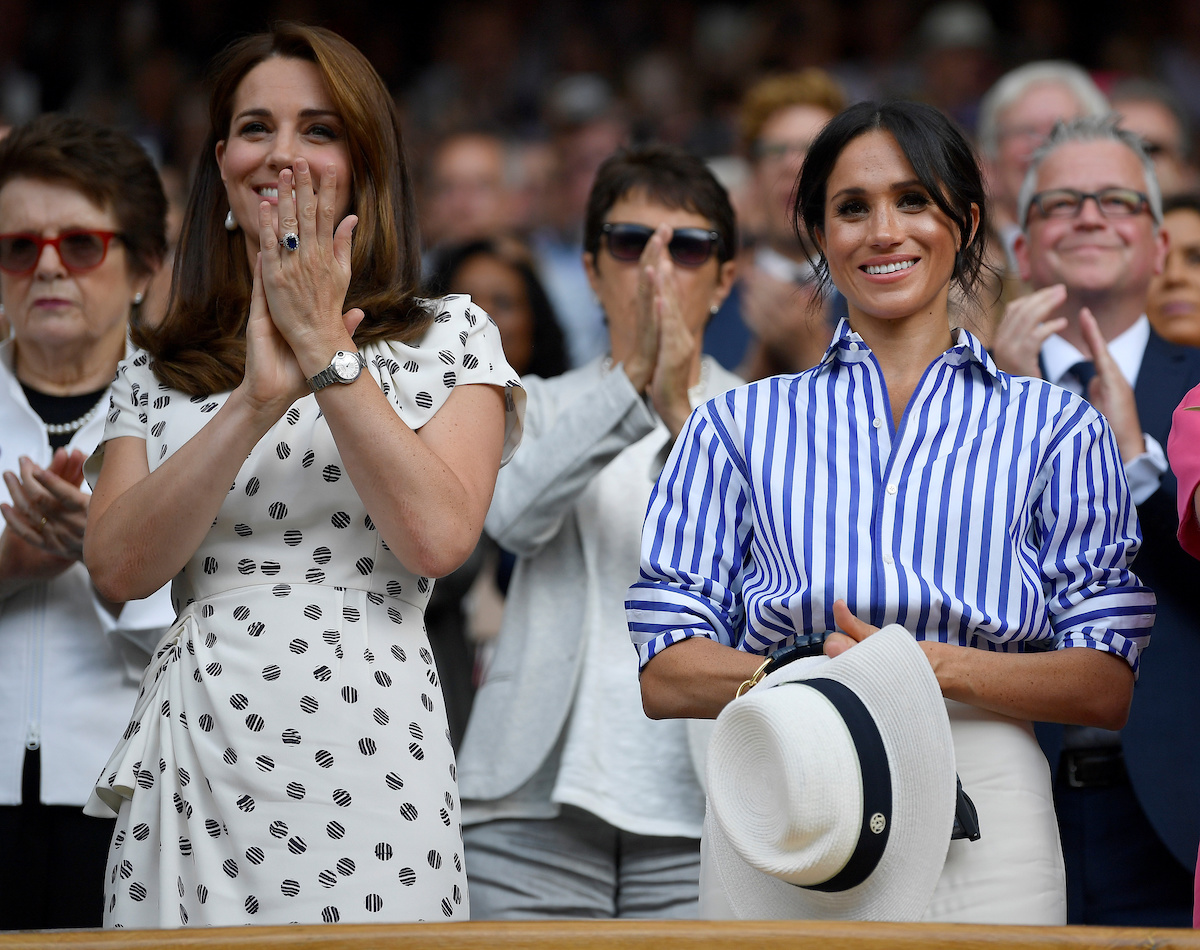 Tennis - Wimbledon - All England Lawn Tennis and Croquet Club, London, Britain - July 14, 2018. Britain's Catherine the Duchess of Cambridge and Meghan the Duchess of Sussex applaud after Germany's Angelique Kerber won the women's singles final against Serena Williams of the U.S. REUTERS/Toby Melville