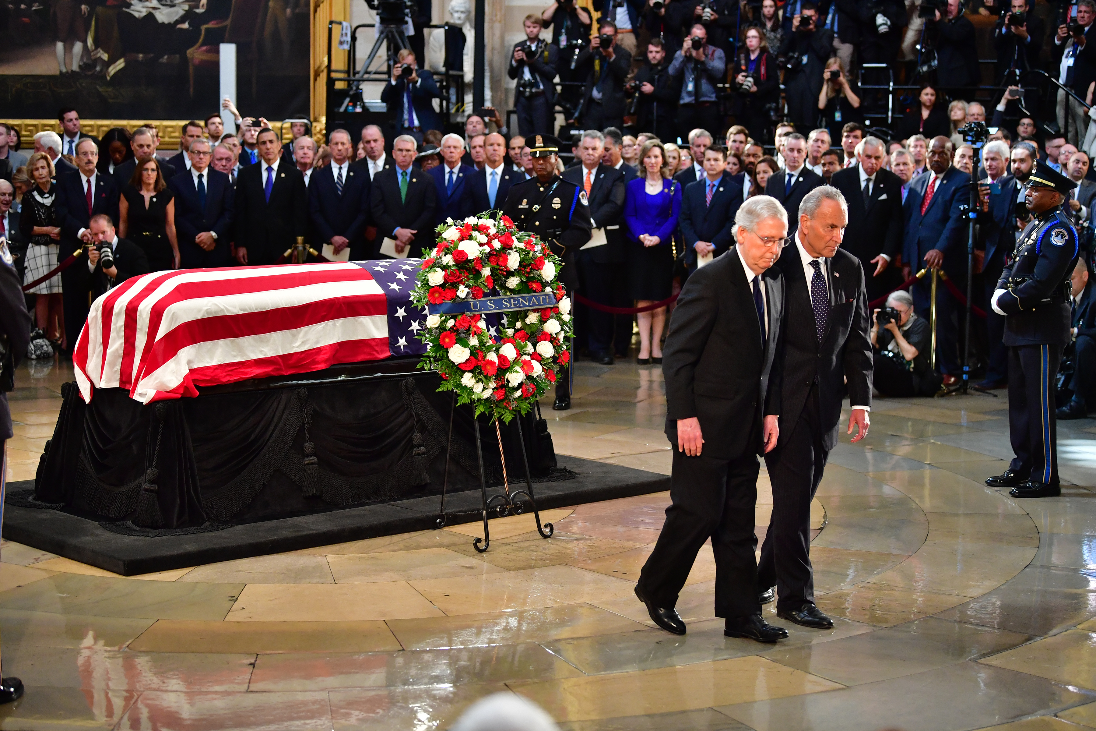 Senators Chuck Schumer and Mitch McConnell walk after viewing the casket of former Senator John McCain in the Capitol Rotunda where he will lie in state (Kevin Dietsch - Pool/Getty Images)