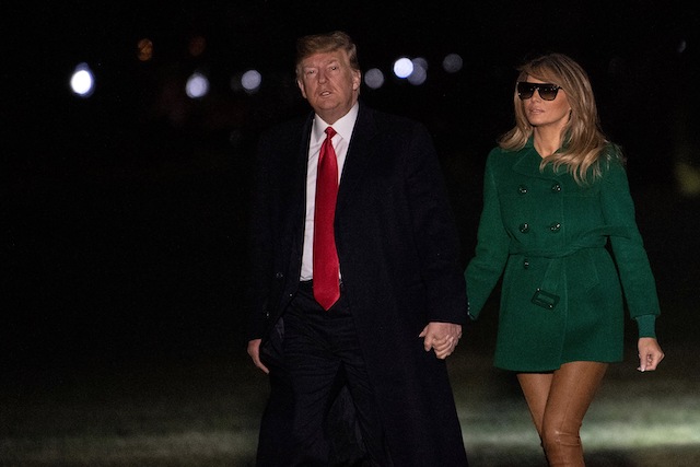 US President Donald Trump and First Lady Melania Trump arrive at the White House in Washington, DC, on December 27, 2018, as they return from an unannounced trip to Iraq. - President Donald Trump used a lightning visit to Iraq -- his first with US troops in a conflict zone since being elected -- to defend the withdrawal from Syria and to declare an end to America's role as the global "policeman." (Photo credit: NICHOLAS KAMM/AFP/Getty Images)