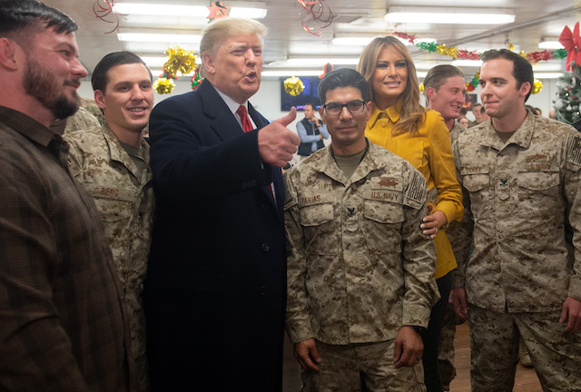 US President Donald Trump and First Lady Melania Trump greet members of the US military during an unannounced trip to Al Asad Air Base in Iraq on December 26, 2018. - President Donald Trump arrived in Iraq on his first visit to US troops deployed in a war zone since his election two years ago (Photo credit: SAUL LOEB/AFP/Getty Images)