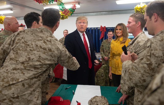 US President Donald Trump and First Lady Melania Trump greet members of the US military during an unannounced trip to Al Asad Air Base in Iraq on December 26, 2018. (Photo credit: SAUL LOEB/AFP/Getty Images)